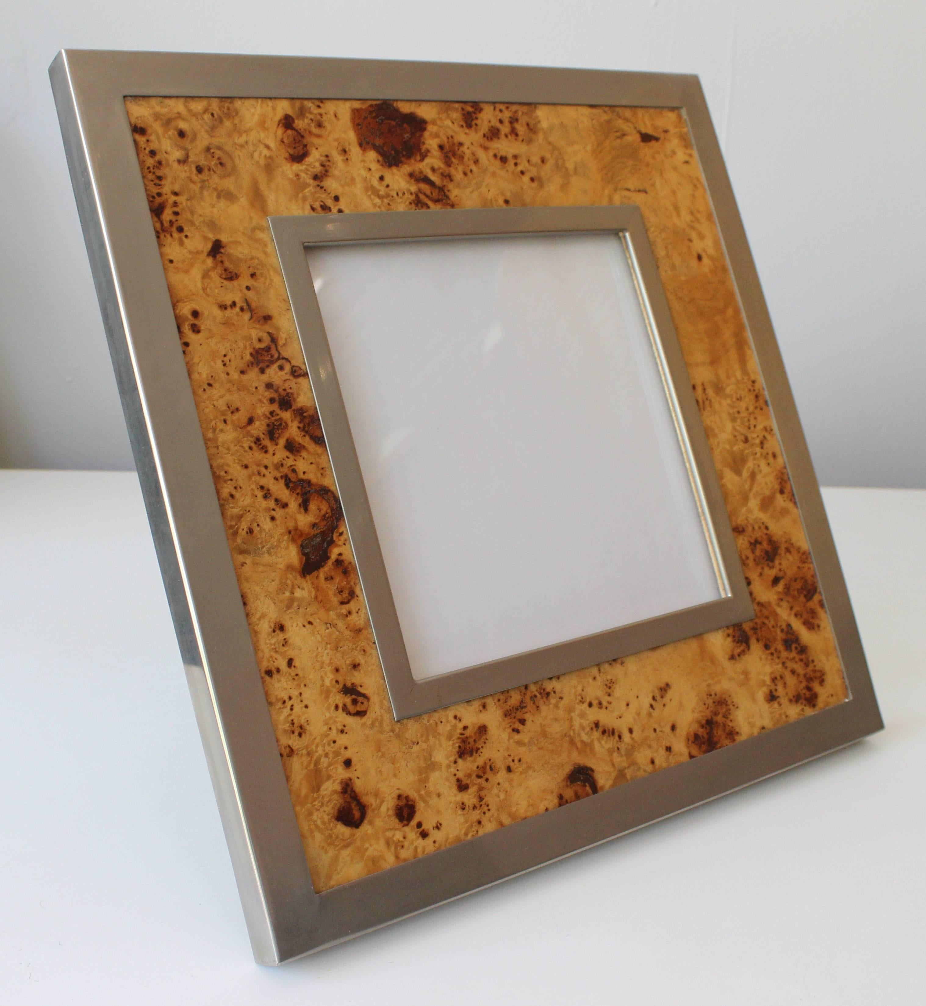 A brushed steel and burled olivewood picture frame designed by Willy Rizzo.
Two available.