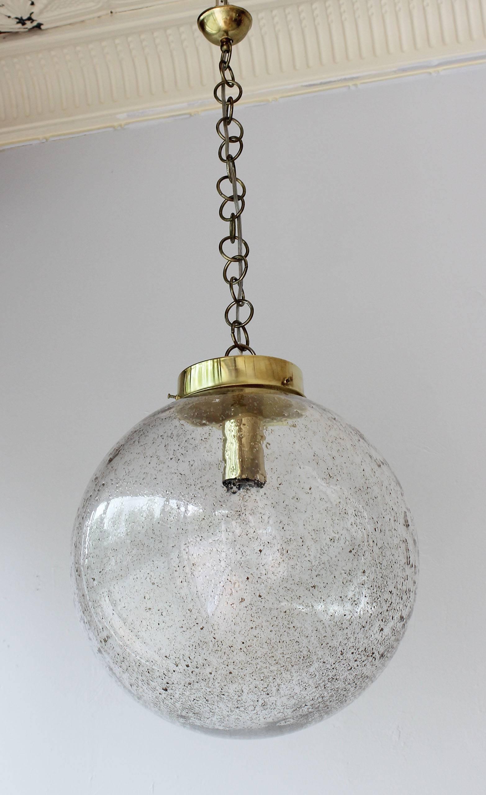 A gorgeous Murano glass globe with gold flecks and brass details.

17 in chain shown.
4