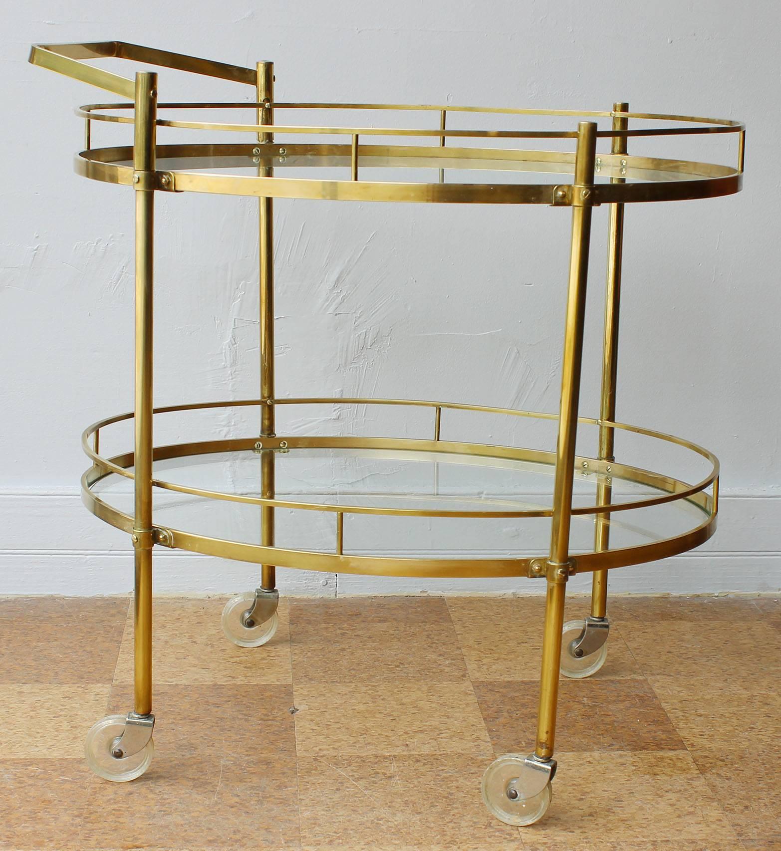 A 1960s two-tier solid brass server/ bar cart/ trolley with glass inserts and removable handle by Maxwell Phillips, NYC.