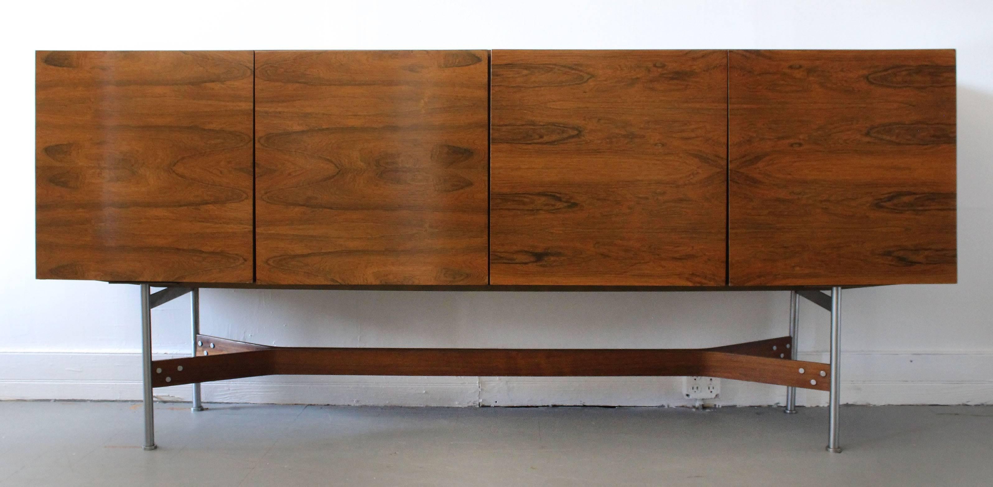 A Mid-Century rosewood sideboard, designed by Rudolf Bernd Glatzel for Fristho Franeker, featuring clean lines and bookmatched cabinet doors, on steel frame.