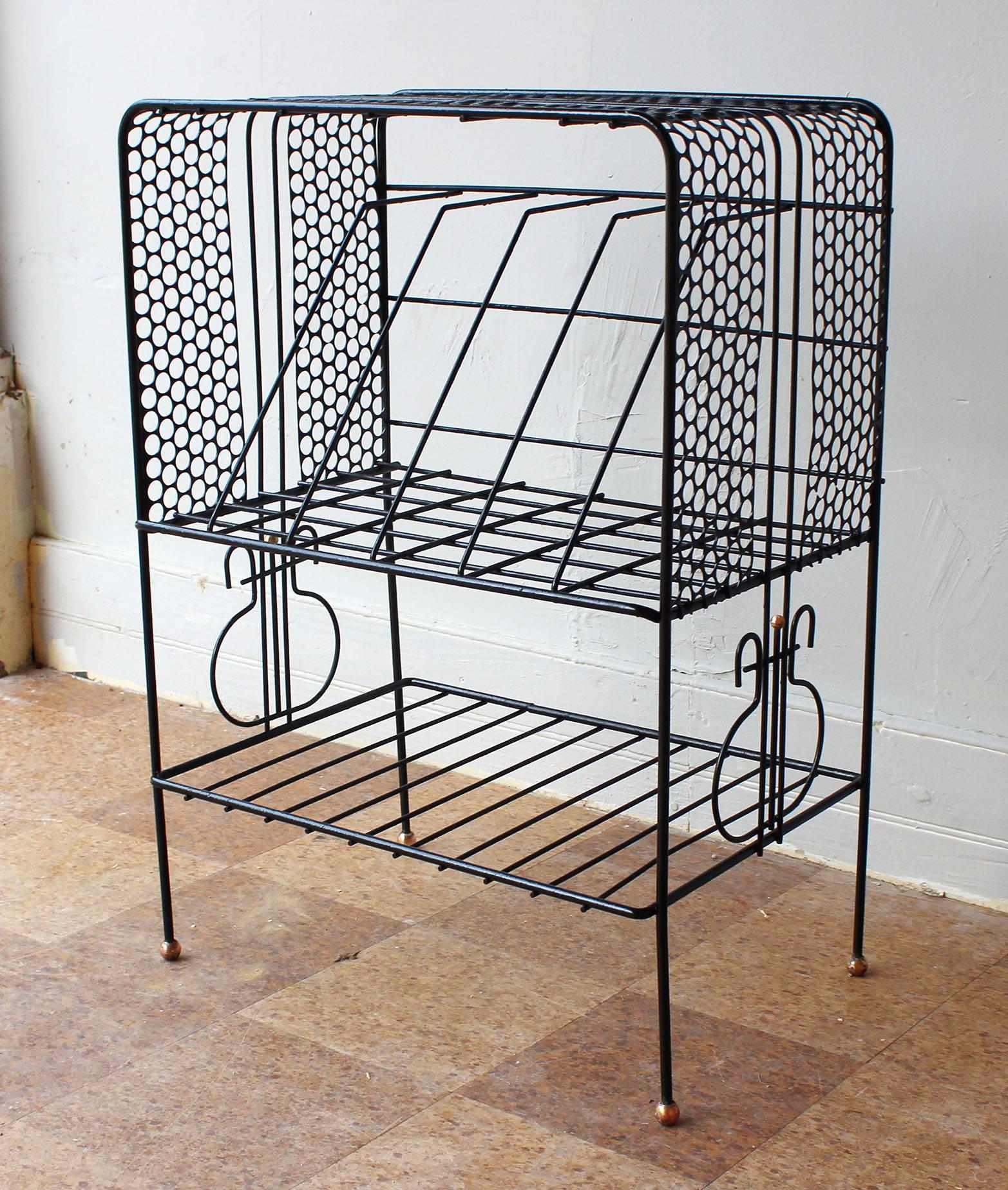 A charming Mategot style wrought iron record holder and magazine rack with brass foot details.

complementary delivery within 30 miles.