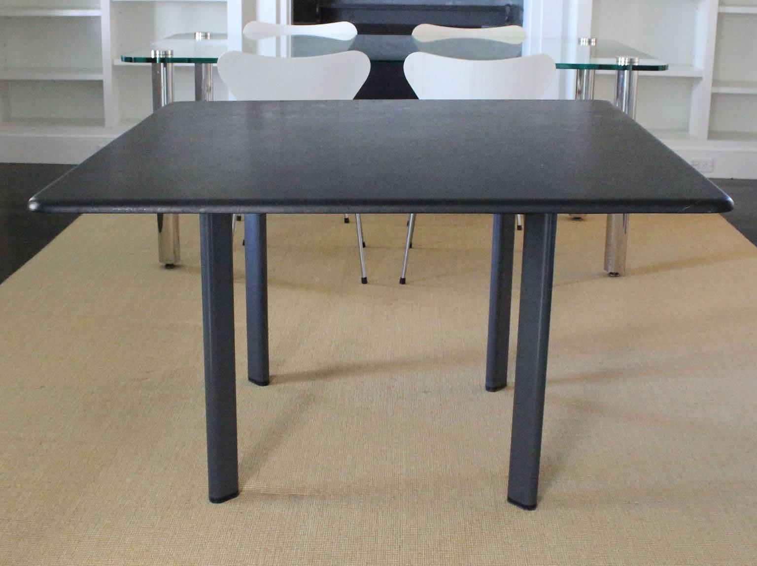 A granite top table with enameled metal legs designed by Joe D'Urso for Knoll.

complementary shipping within 30 miles.