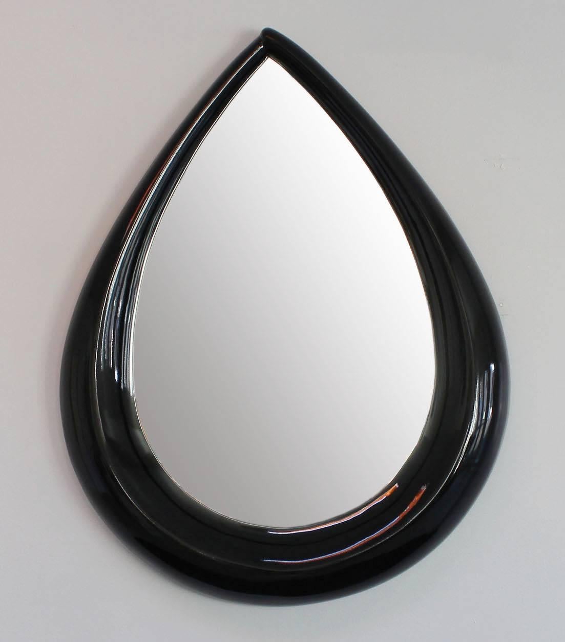 A sculptural black lacquered teardrop mirror in the manner of Wendell Castle.
Matching shelf also available.

complimentary delivery within 30 miles.

