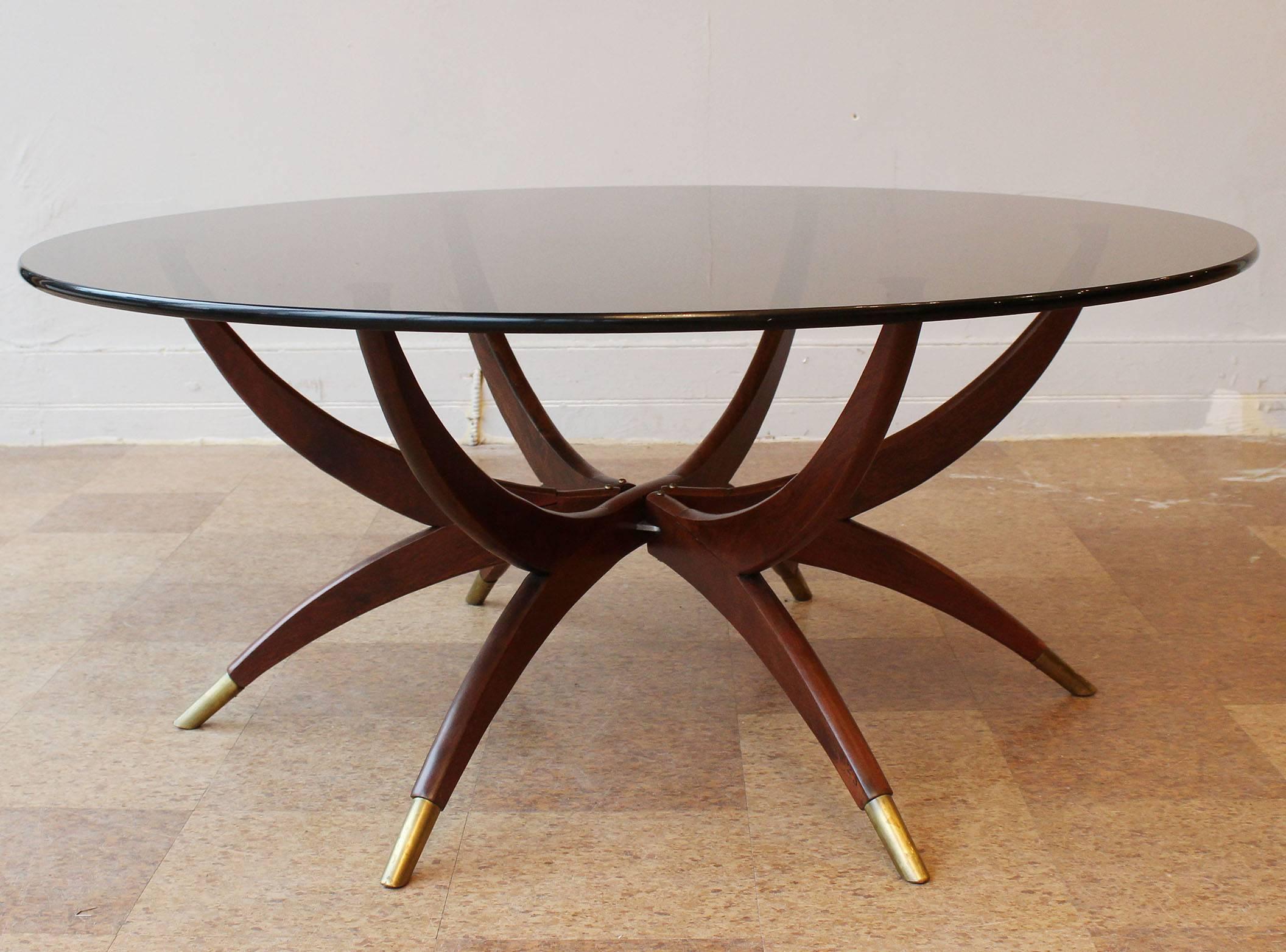 An Italian collapsible wood frame coffee table with brass sabots in the manner of Carlo de Carli.

Collapses to 34