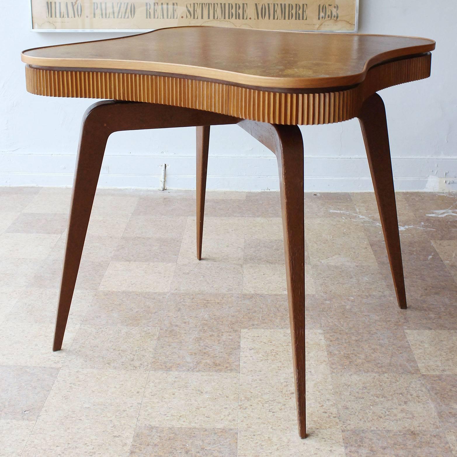 A Mid-Century wood game or dining table with four drawers and ribbed details in the manner of Paolo Buffa.

complementary delivery within 30 miles.