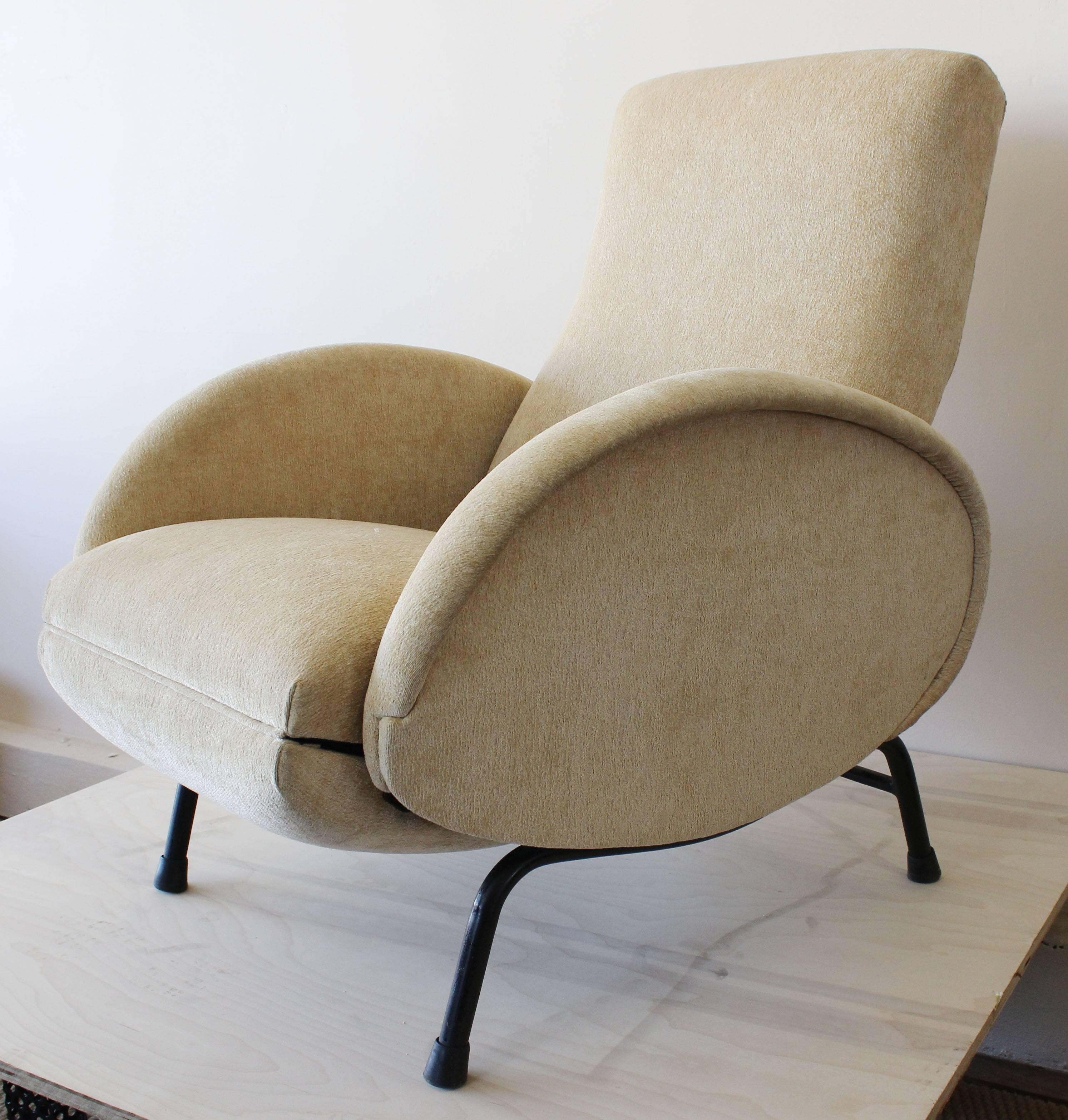 A Mid-Century Italian armchair with metal base and vintage upholstery by Poltronissima Dormiveglia. Opens to 63 inches.