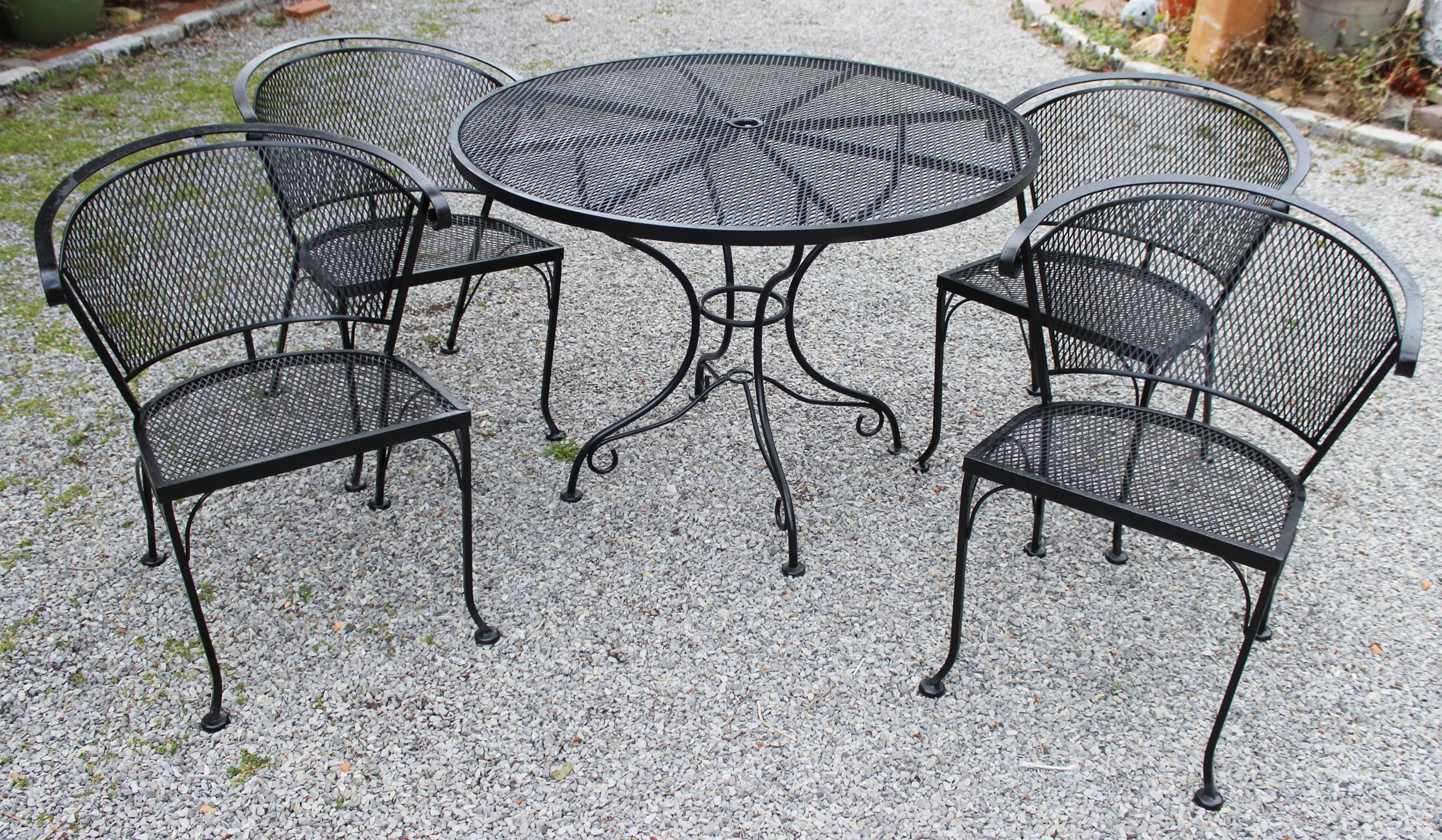 A round iron garden table and four chairs by Salterini.

Chair dimensions:
29.5 inches H x 24.25 W x 23.25 D (seat height 16 inches).