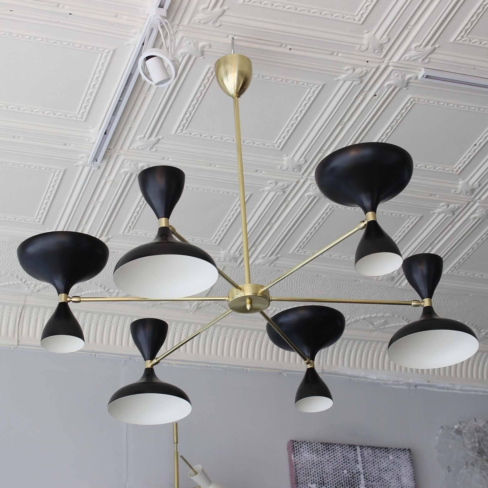 Our own exclusive sunburst design Milano chandelier, with six brass arms and pivoting powdercoated heads with up and down sockets. In black or white or both. All made in Italy.

12 shade chandelier and sconces also available.

