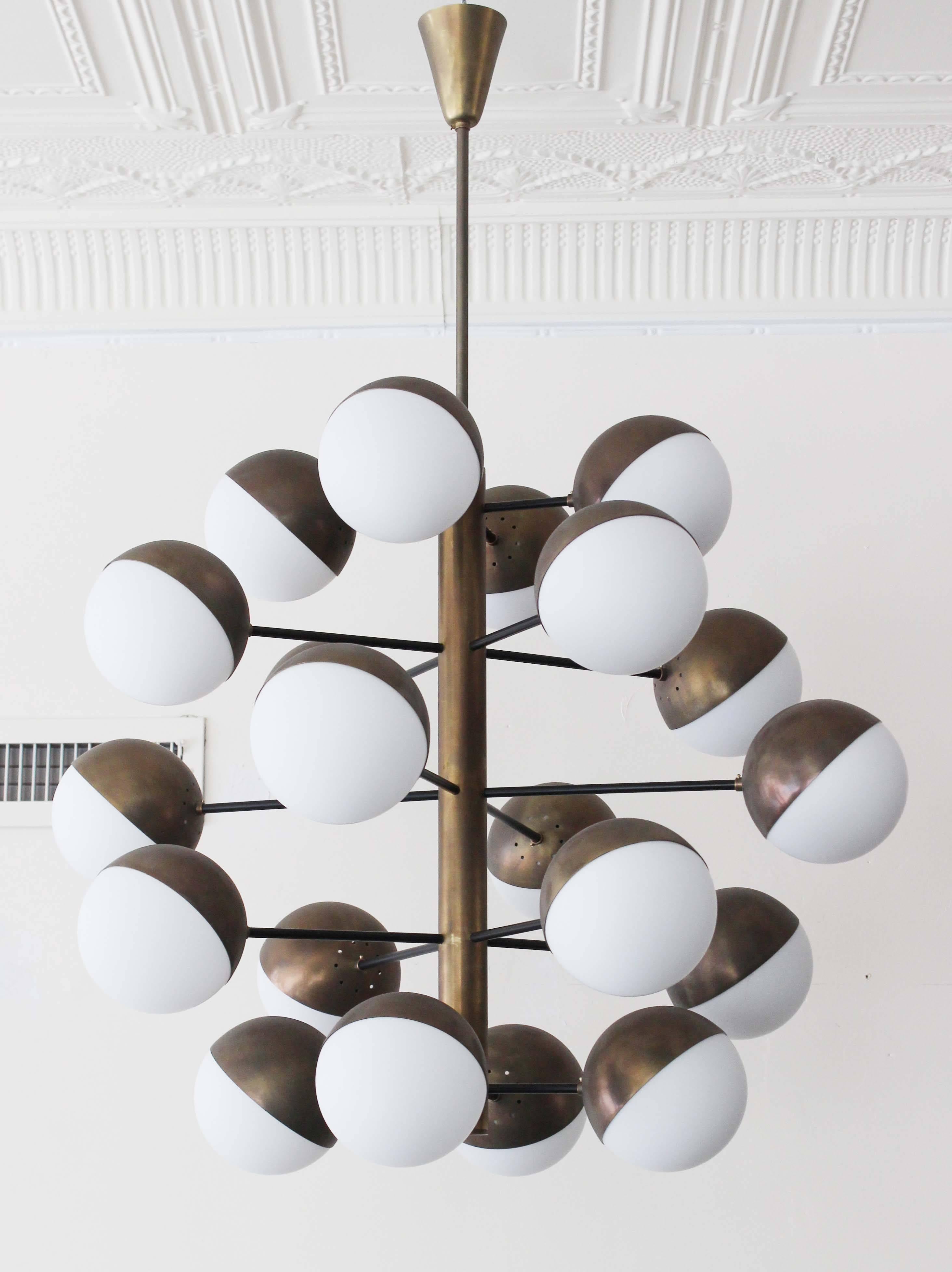 A magnificent bronzed metal 20 globe stem Stilnovo style chandelier with milk glass.

Measures: 6" diameter globes.
Stem and ceiling cap 18" (incl 5" cap).
 
