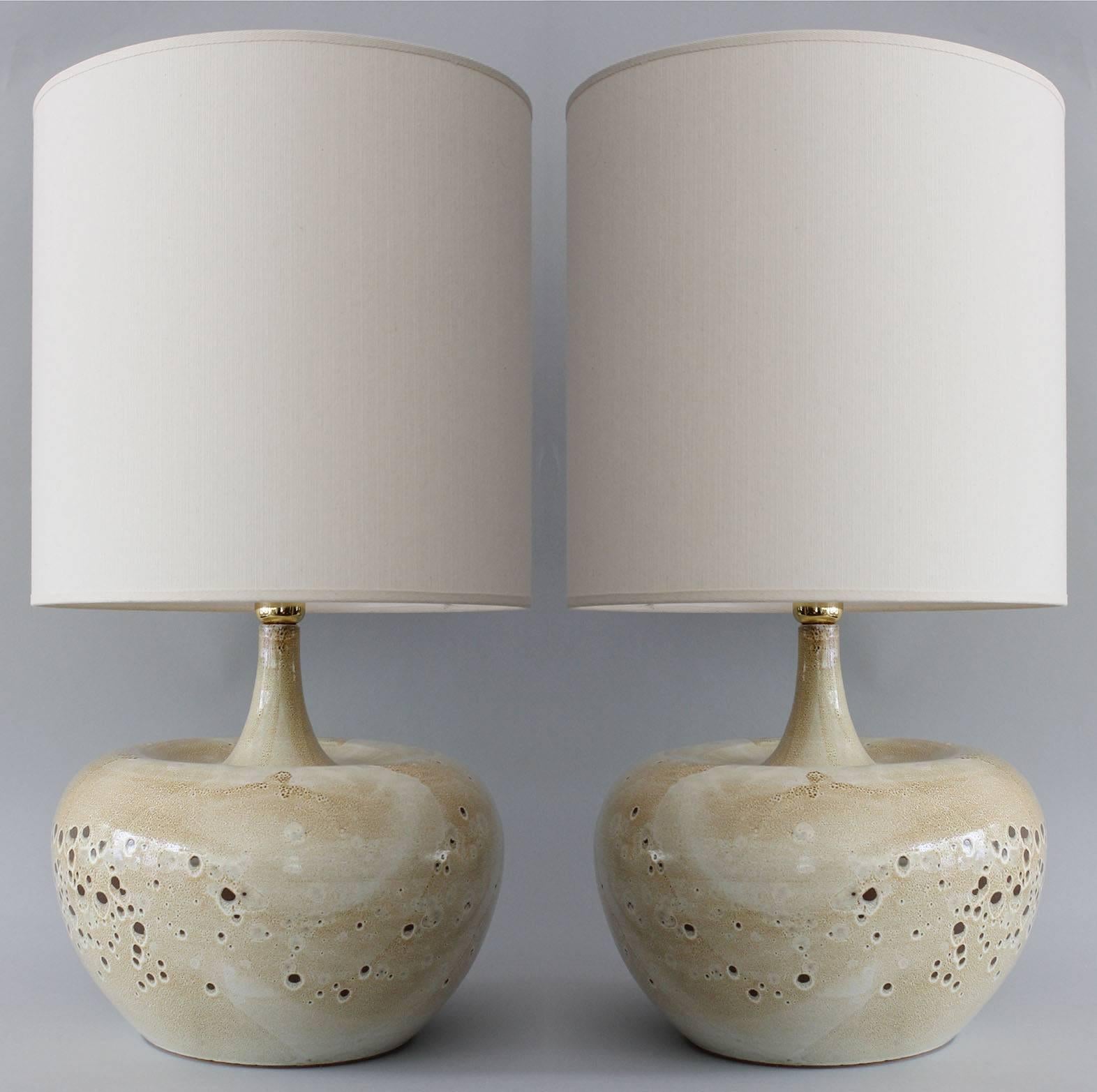 A pair of Italian ceramic lamps with sandy speckled glaze and brass details.

Shades for photography only.

Height measurement is to top of brass detail.