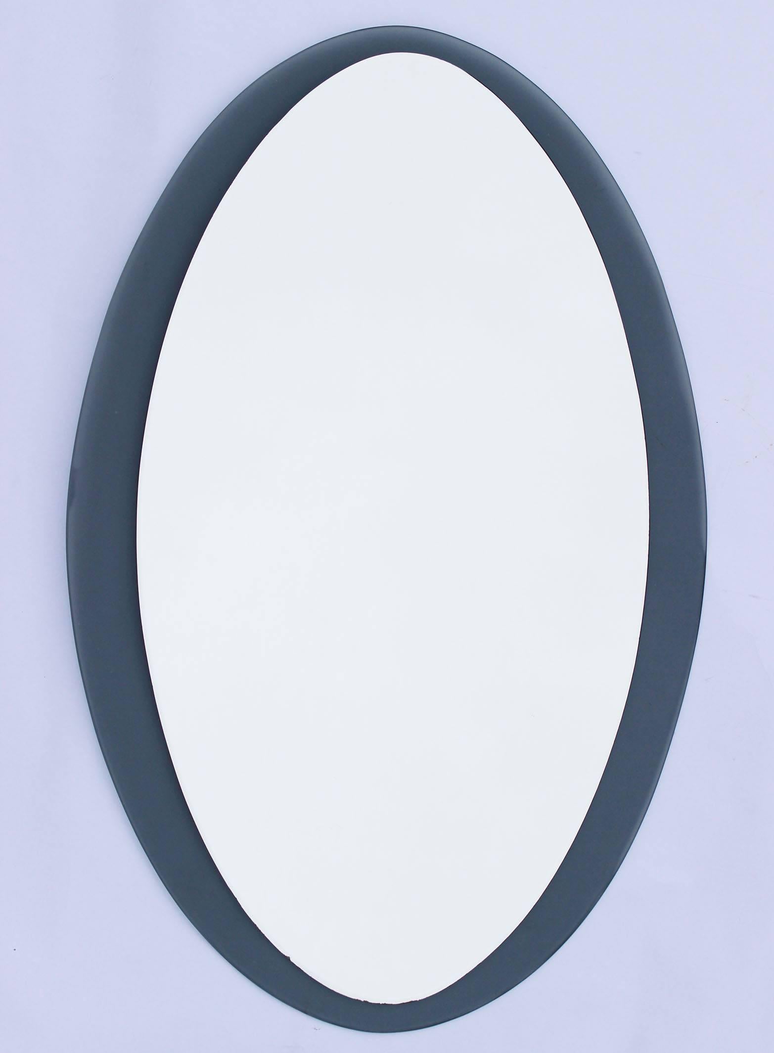 A Mid-Century Fontana Arte style translucent grey glass mirror.