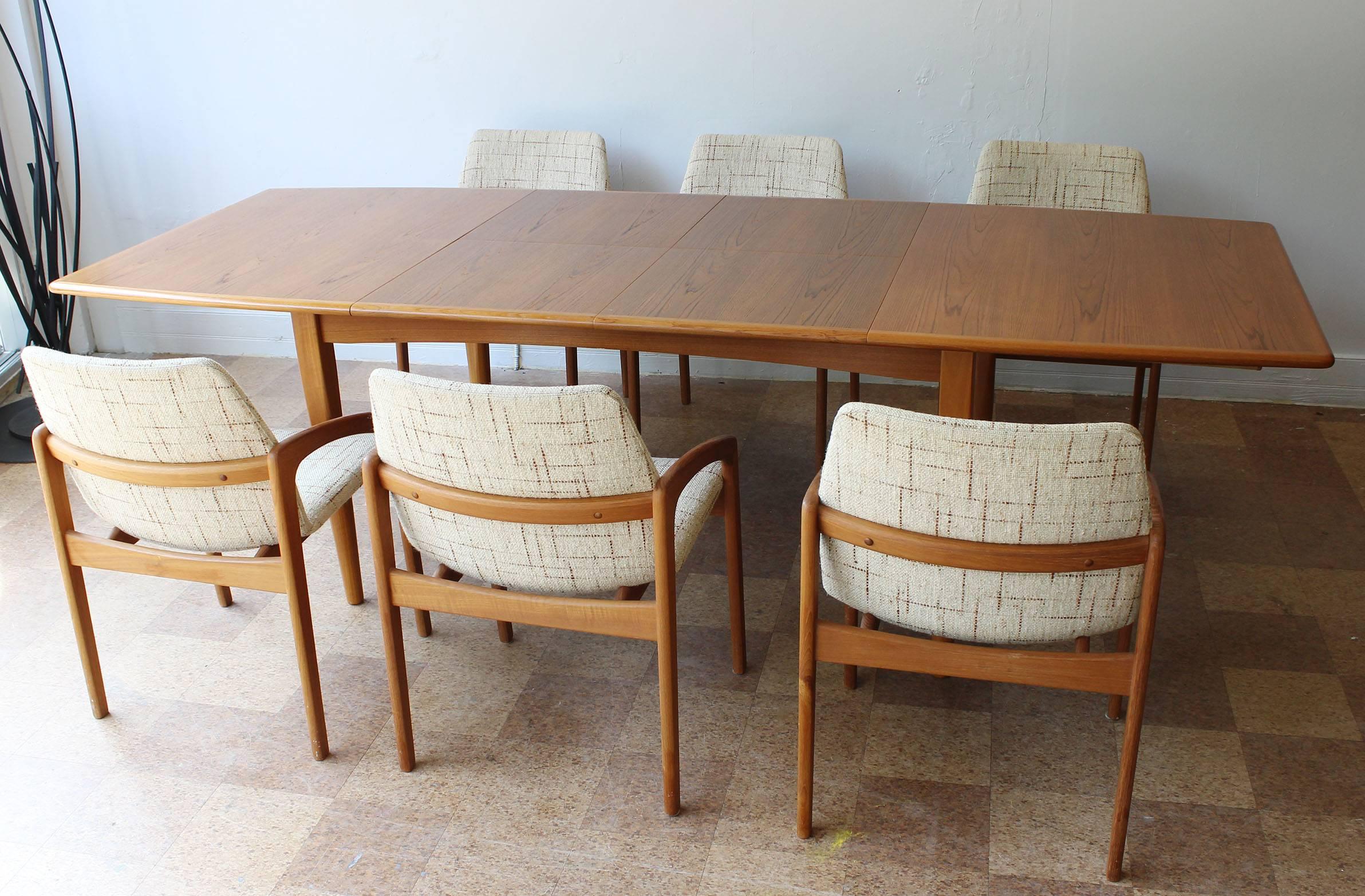 An expandable teak dining table and six chairs by Kai Kristiansen, with two interior 19.5 inch leaves,

table opens to 101" wide

chairs. 
Measures: 31" H (17.25" sh) x 21 W x 23 D.