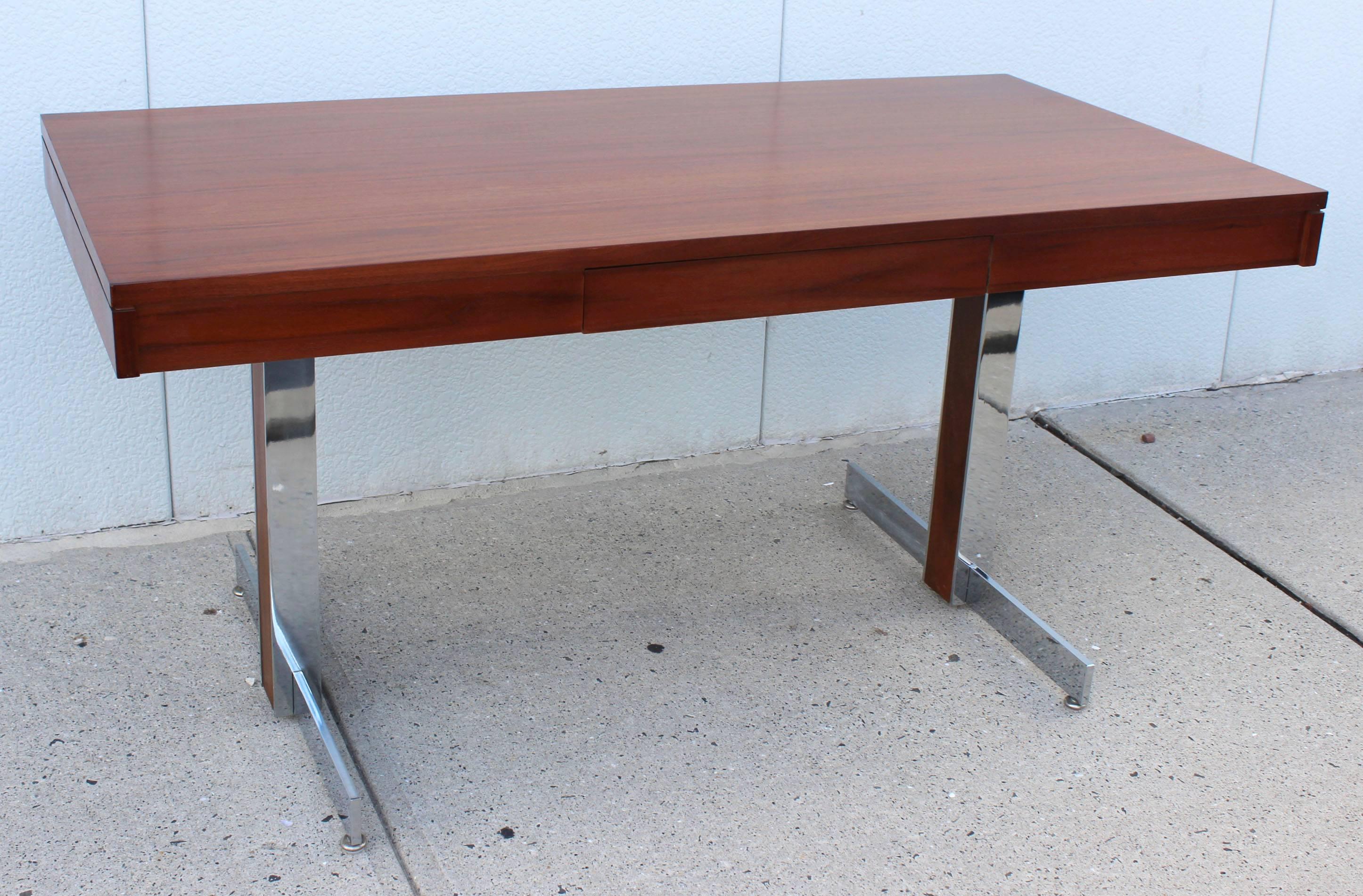 A Milo Baughman style sleek and modern chrome frame desk with rosewood top and leg inlay detail.