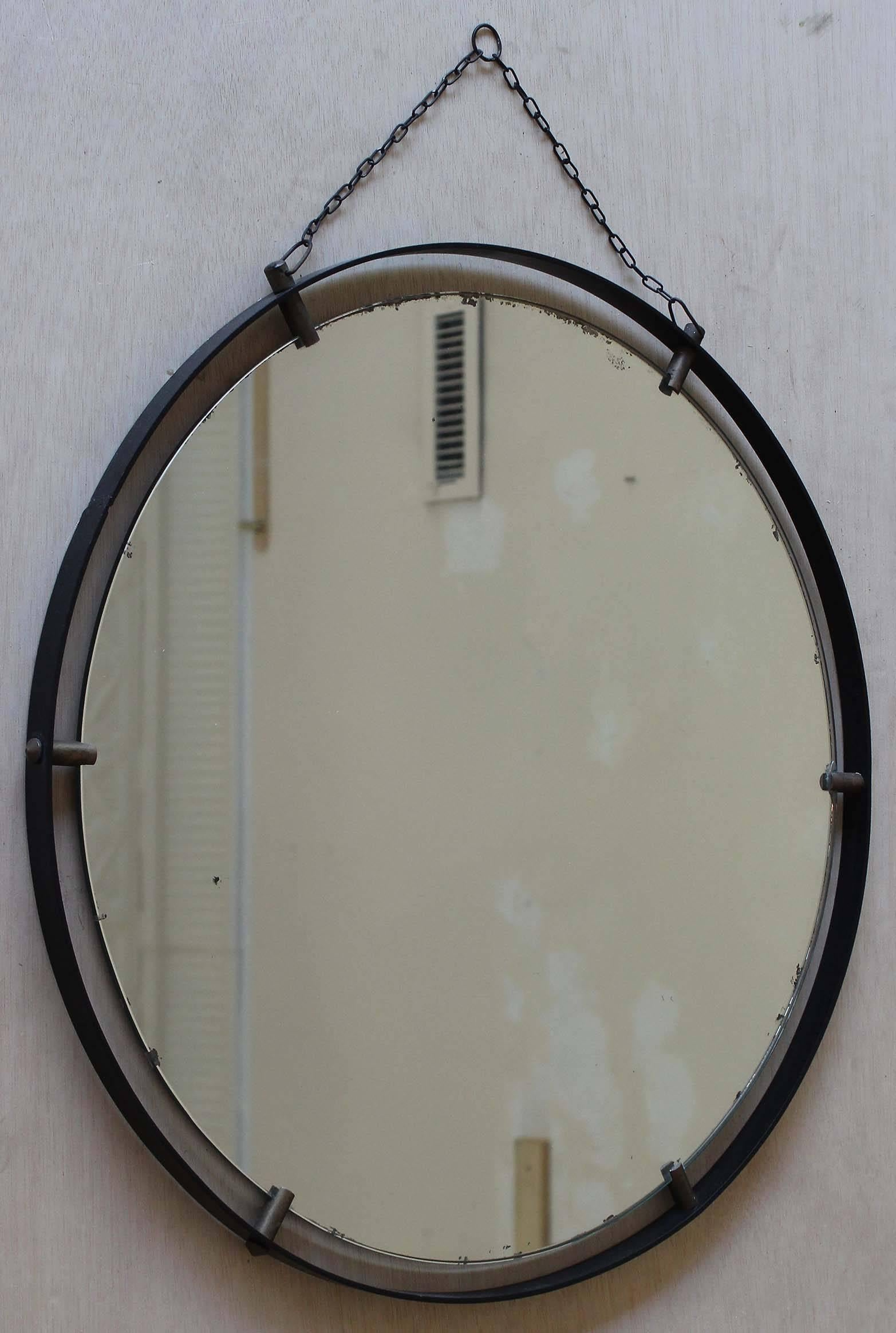 An Italian iron frame mirror with brass hardware and chain links.