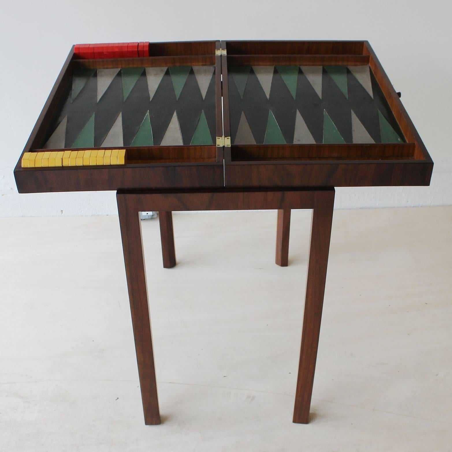 A Tommi Parzinger custom-made folding backgammon table with leather top and bakelite gaming pieces. Acquired directly from Parzinger's estate by previous owner who was a neighbor and collector. Lightly restored. Measures: Table opens to 29.5 inches