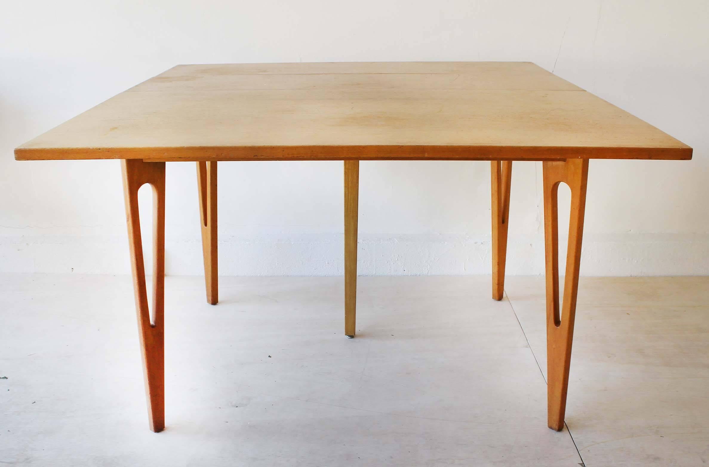 A Mid-Century fold-top maple wood table with three leaves, in the manner of Edmond Spence.
Each leaf measures 11 x 41.5 inches.
fully closed measures: 23.5 x 41.5 x 30.5H.