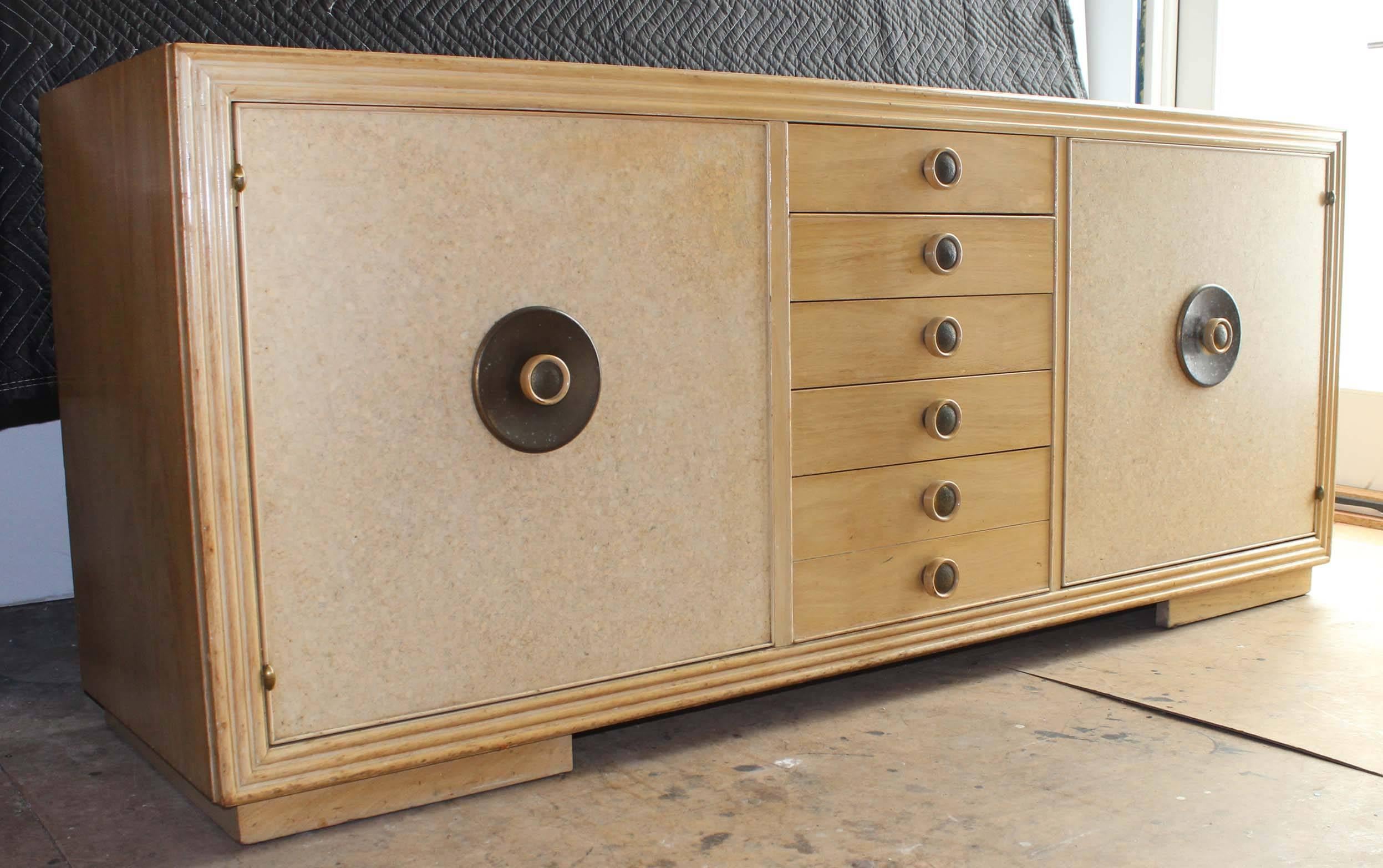 A maple wood sideboard with signature cork front cabinets and patinaed brass hardware.