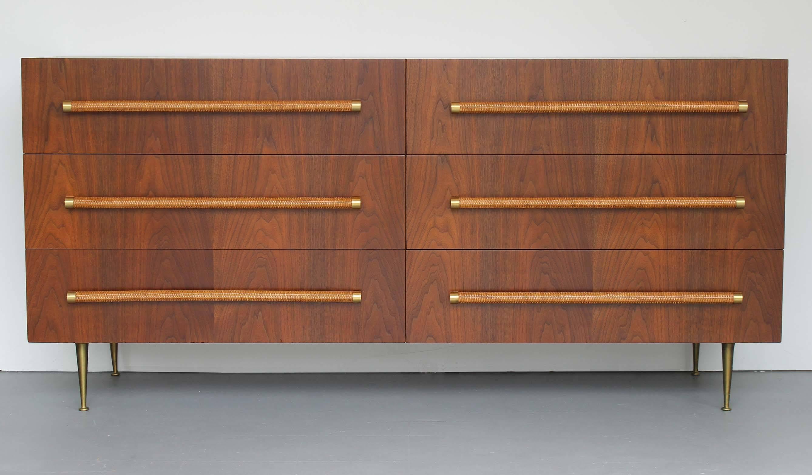 Spectacular six-drawer walnut dresser with woven rattan and brass pulls, and brass legs, by English born American designer T.H. Robsjohn-Gibbings for Widdicomb.