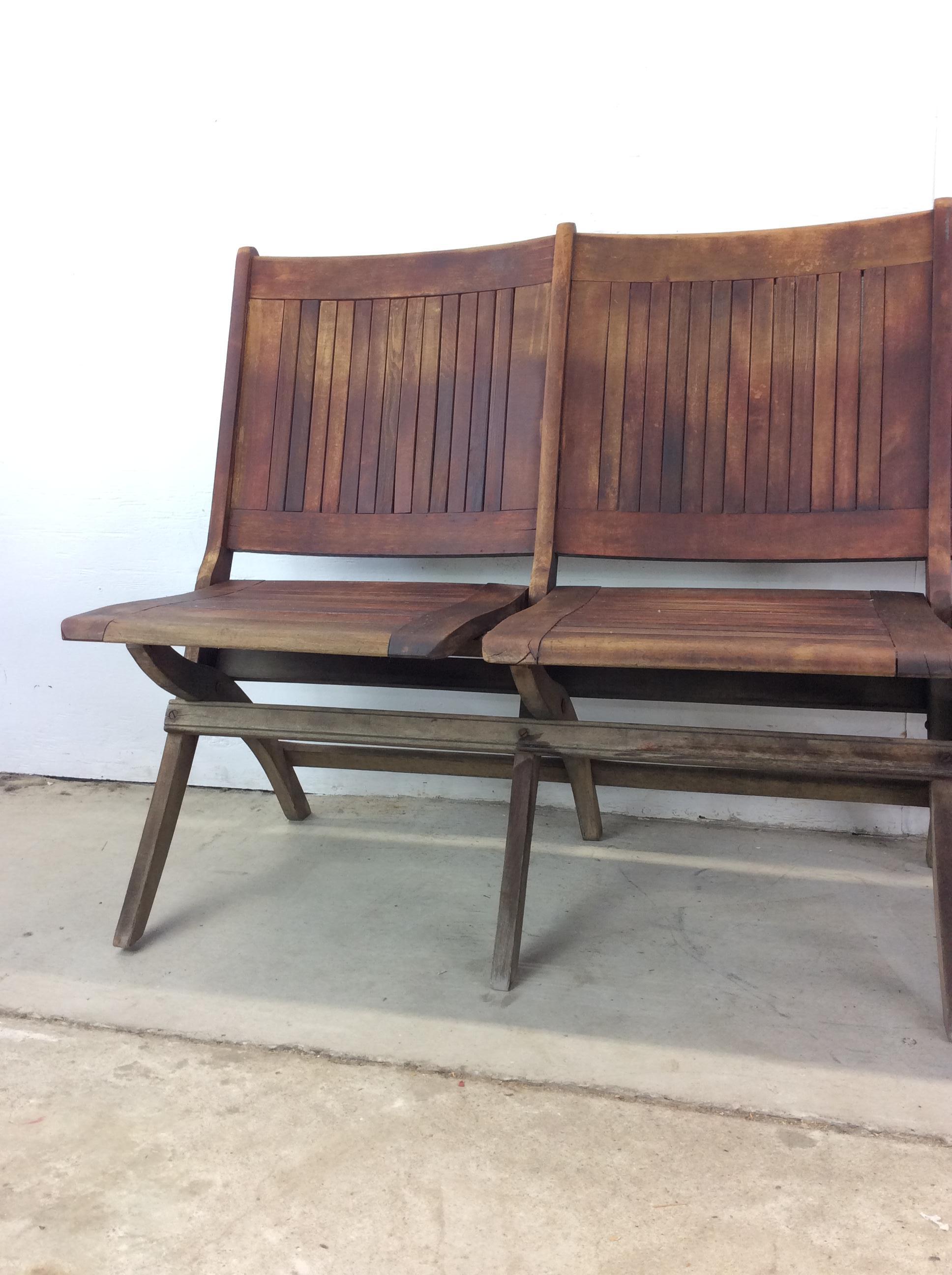 This antique set of theater chairs feature hardwood construction, original dark finish, four individual folding seats, and complete folding frame.

Dimensions: 71.25w 21d 33.5h 16sh 

Condition notes: Original finish has fading from sun. Wood is