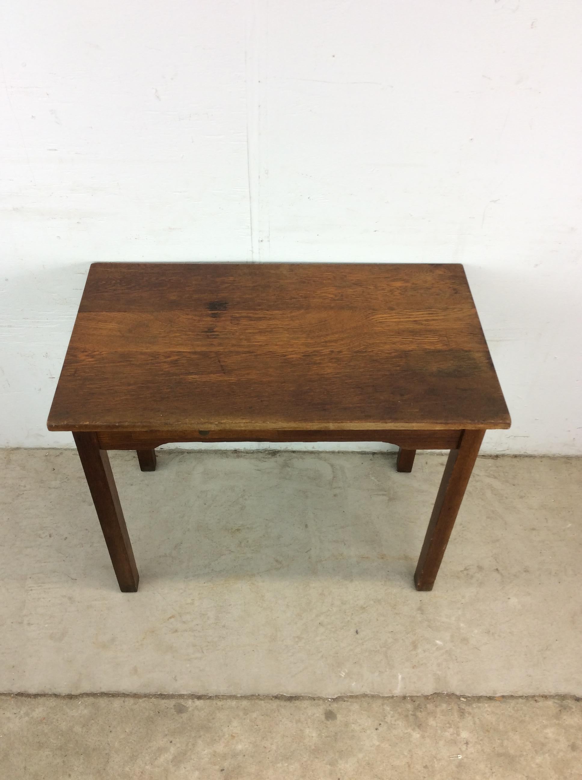 This antique writing desk features hardwood construction, original oak finish, single drawer with brass accented hardware, draw leaf for additional surface area, and finished back.

Dimensions: 32w 18d 26.5h 24.5kh

Condition notes: Original finish