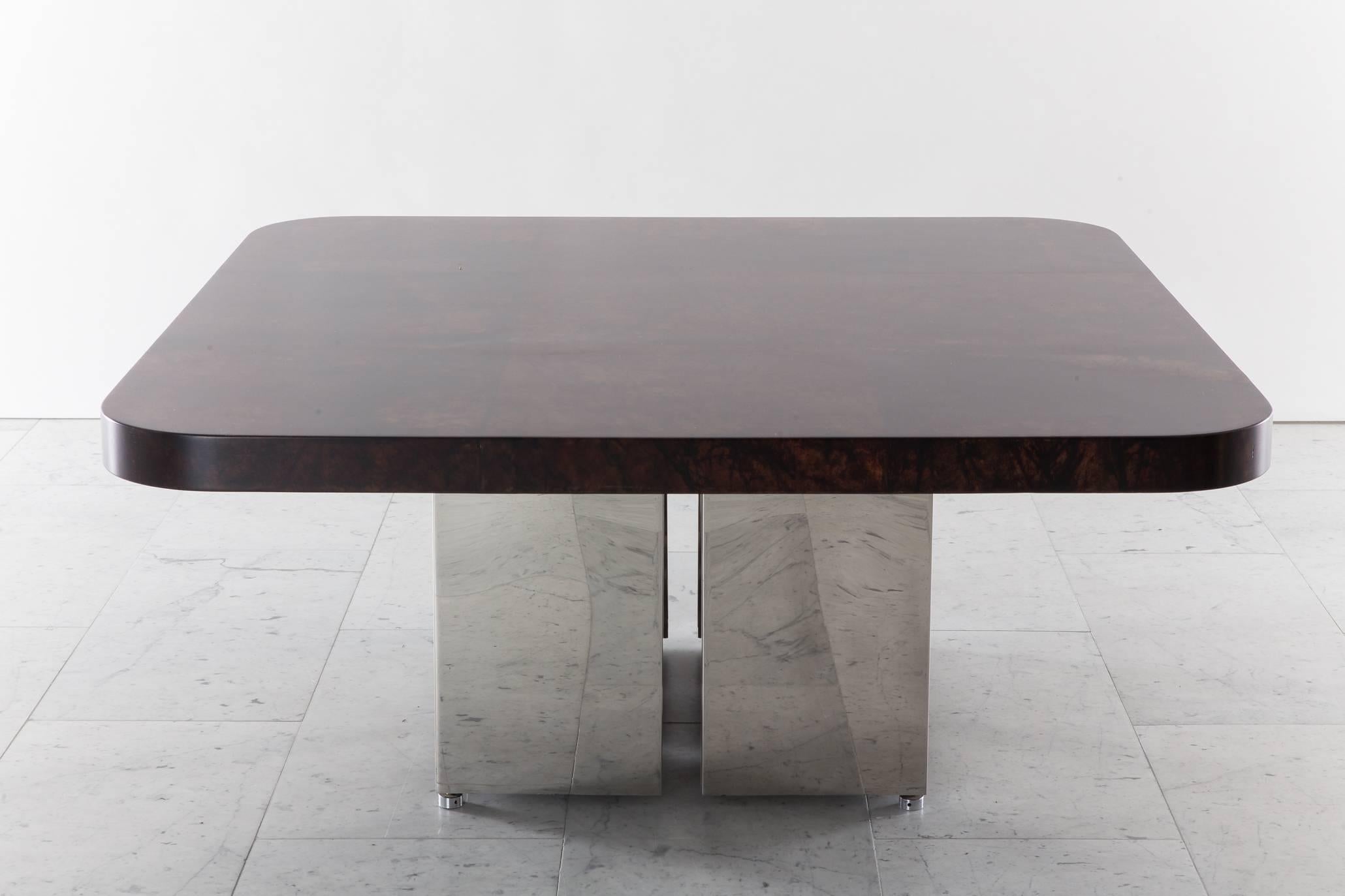 A unique low table with a lacquered heavily grained rich brown goatskin. The polished stainless steel base offers a levity and lightness to the deep, rich brown parchment top, that appears to float. A unique one-off, it is in excellent