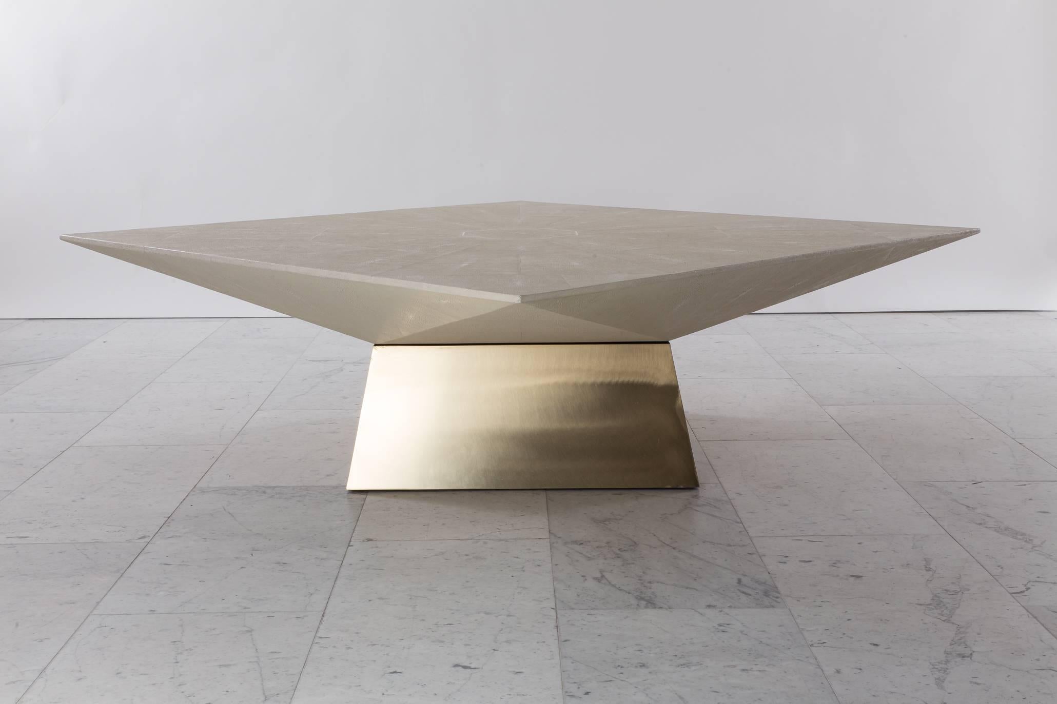 An exquisite low table with a shagreen top and brass base that looks dynamically unique at each angle from which it is viewed. The shagreen features an exquisite octagonal design on its top. 

Today, integrating materials such as shagreen, bone,