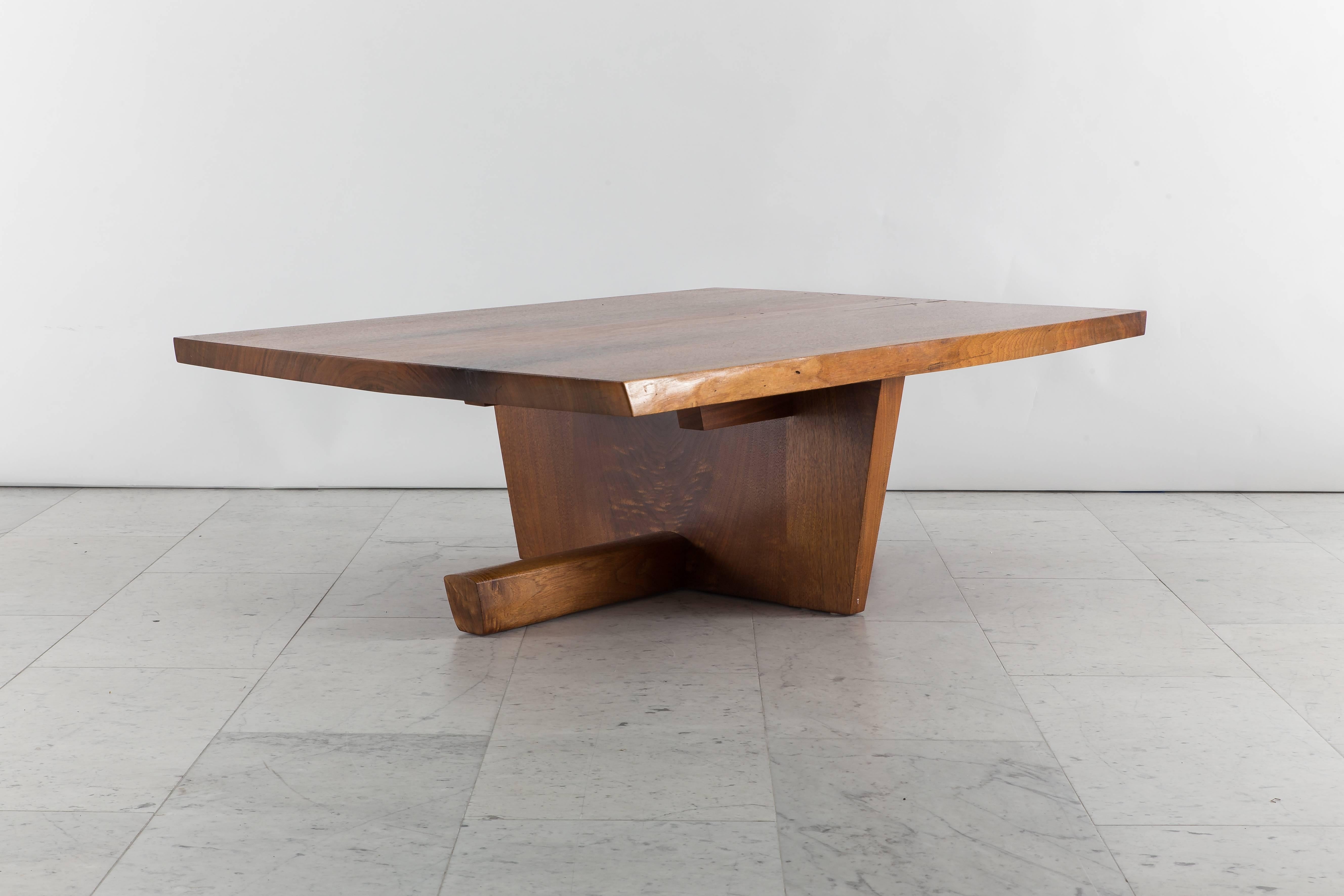 George Nakashima's beautiful Minguren low/cocktail table is substantially sized, handmade of large slabs of East Indian laurel walnut of thicknesses ranging from 2 to 4 inches.

The top features beautiful inclusions and a single elegant butterfly