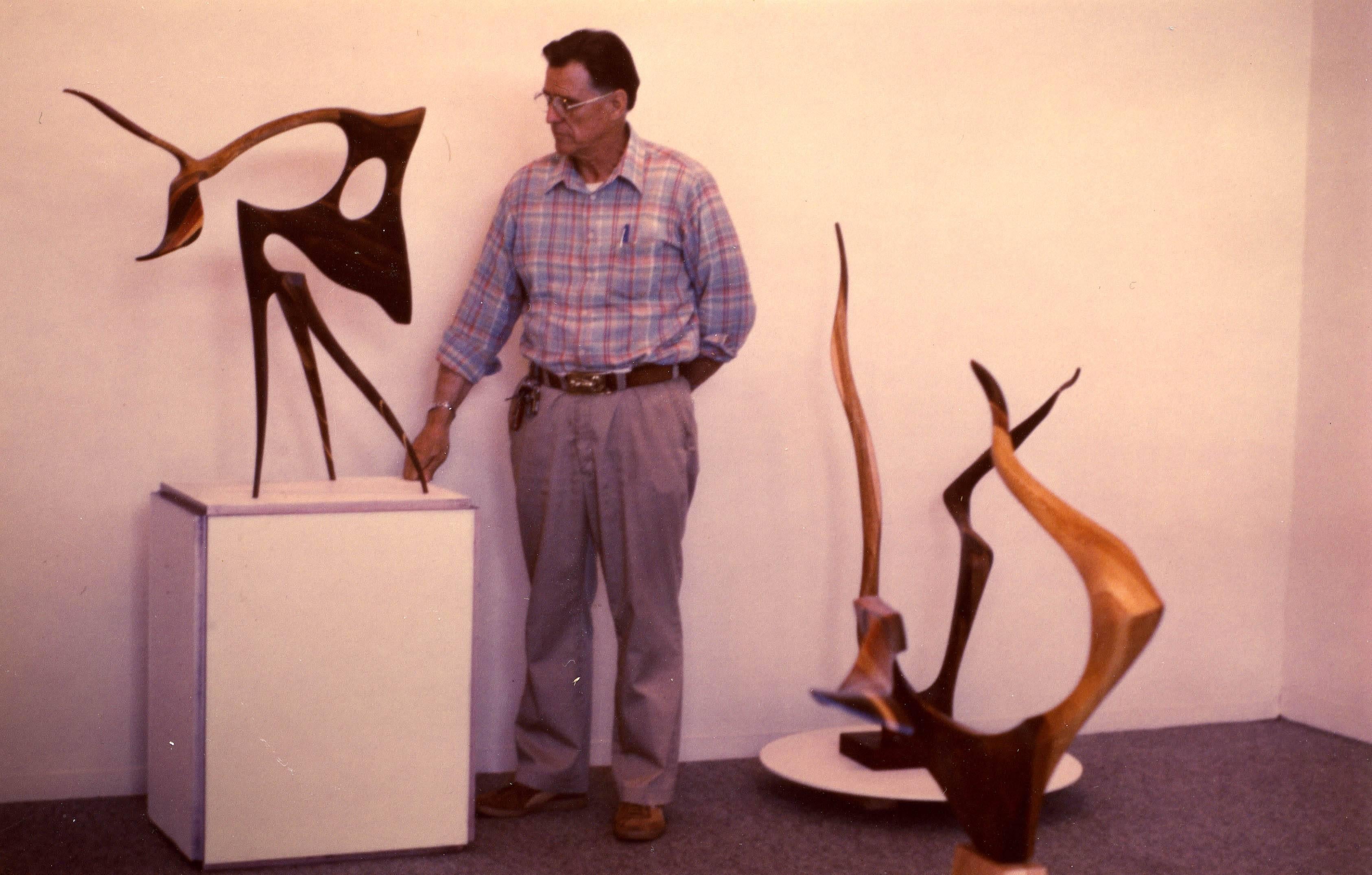 Unique hand-carved walnut sculpture by Jack Rogers Hopkins. USA, circa 1970. A unique sculpture by Jack Rogers Hopkins in hand-carved and laminated American walnut, Honduran mahogany and white oak. The contrast of grains in the laminate accentuate