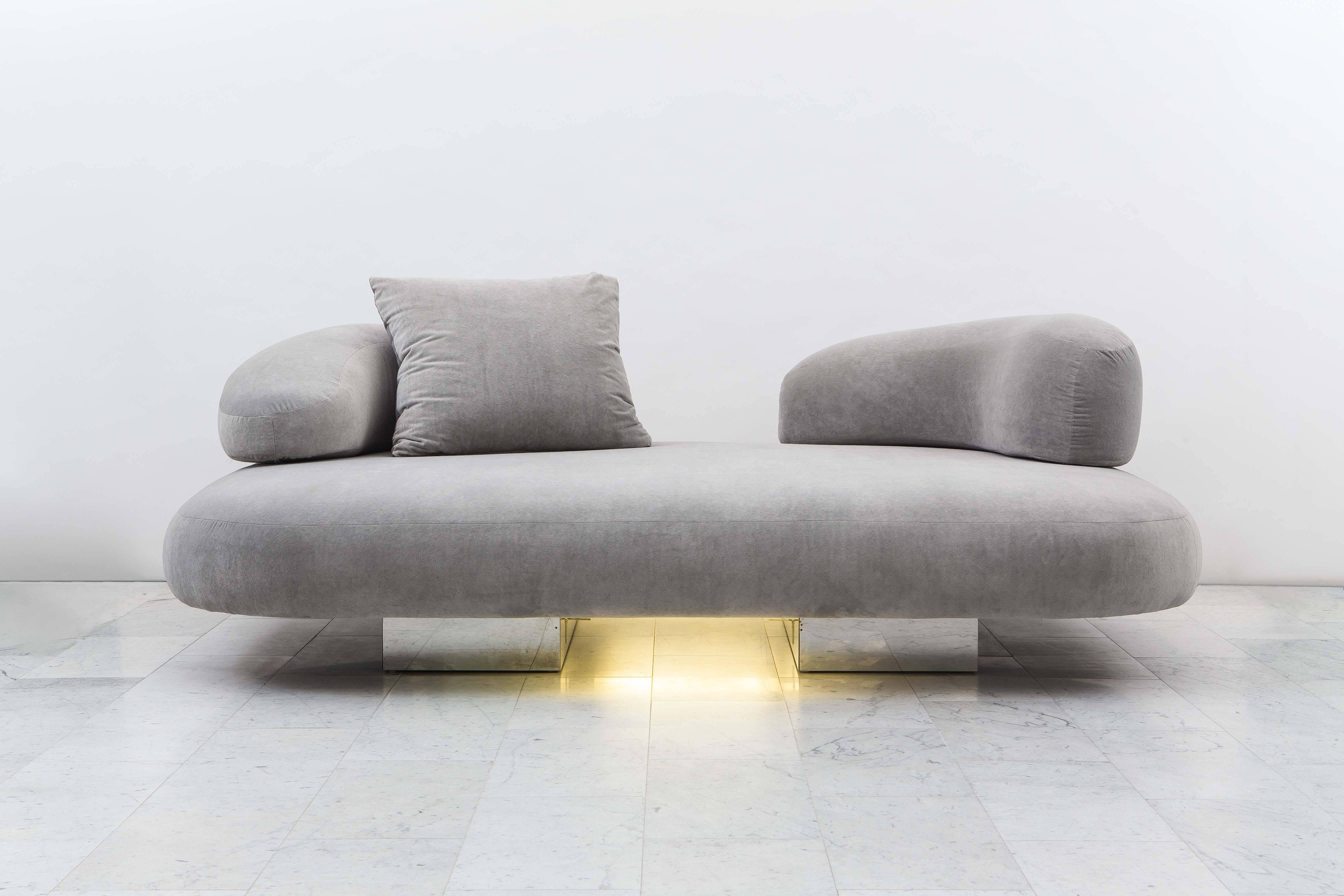 This extra-wide, racetrack shaped-sofa is a rare pre-curser to the final creations made in the 1980s at the end of Evan’s prolific career. Made with architectural and futuristic furniture elements, the voluminous sofa features crescent shaped
