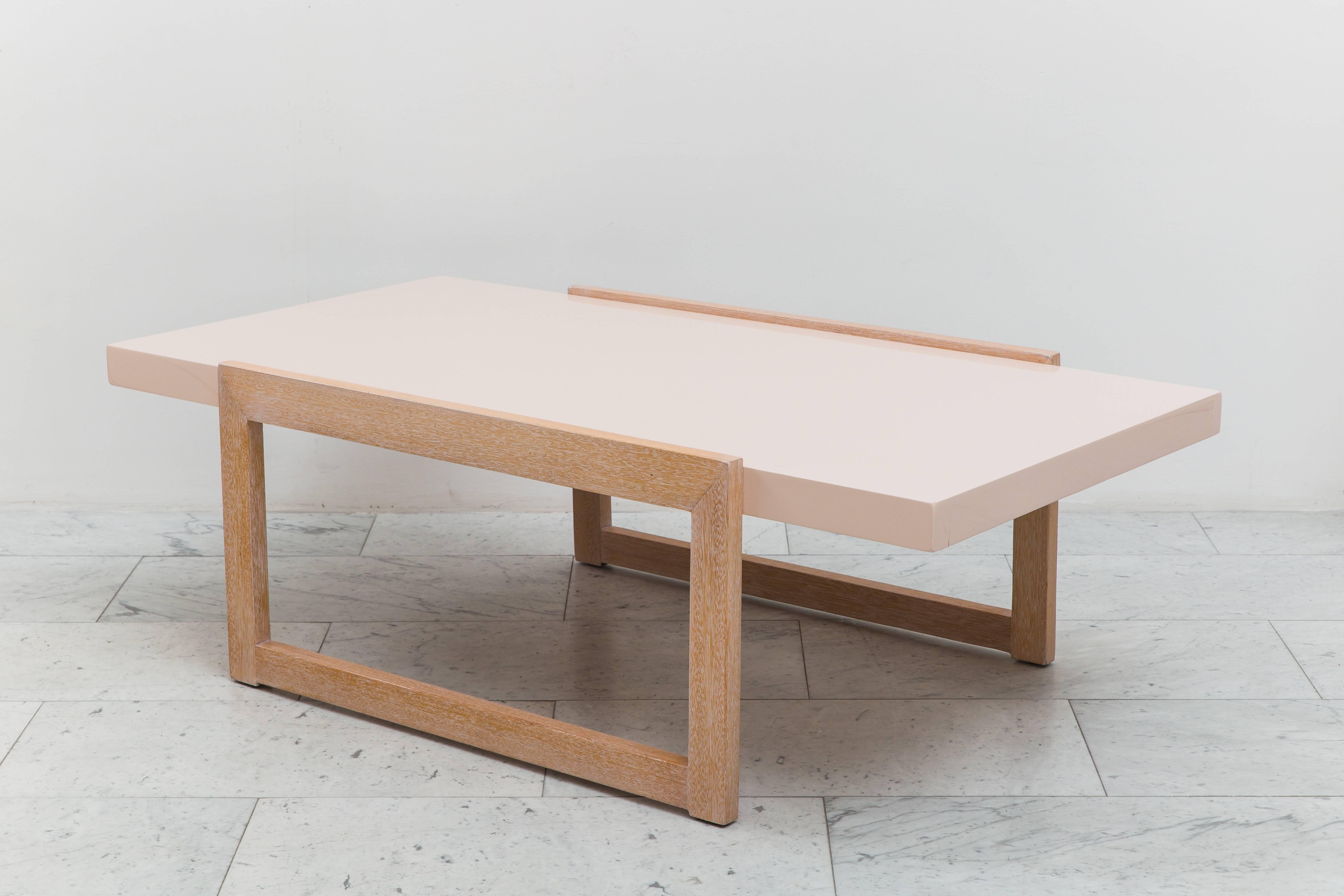 Designed for Brown Saltman this bleached mahogany low table epitomizes Laszlo’s penchant for paired down traditionalism and California modernity. This architectural cocktail table features a shell pink lacquered mahogany top floating on two