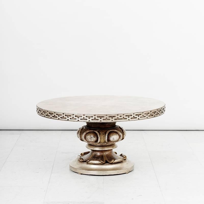 A round top with Chinoiserie fretwork on a beautifully carved column pedestal with a Lotus motif base. The table is finished in silver leaf with gold leaf accents.

Mont’s repertoire is synonymous with Hollywood glamour and the exoticism of the
