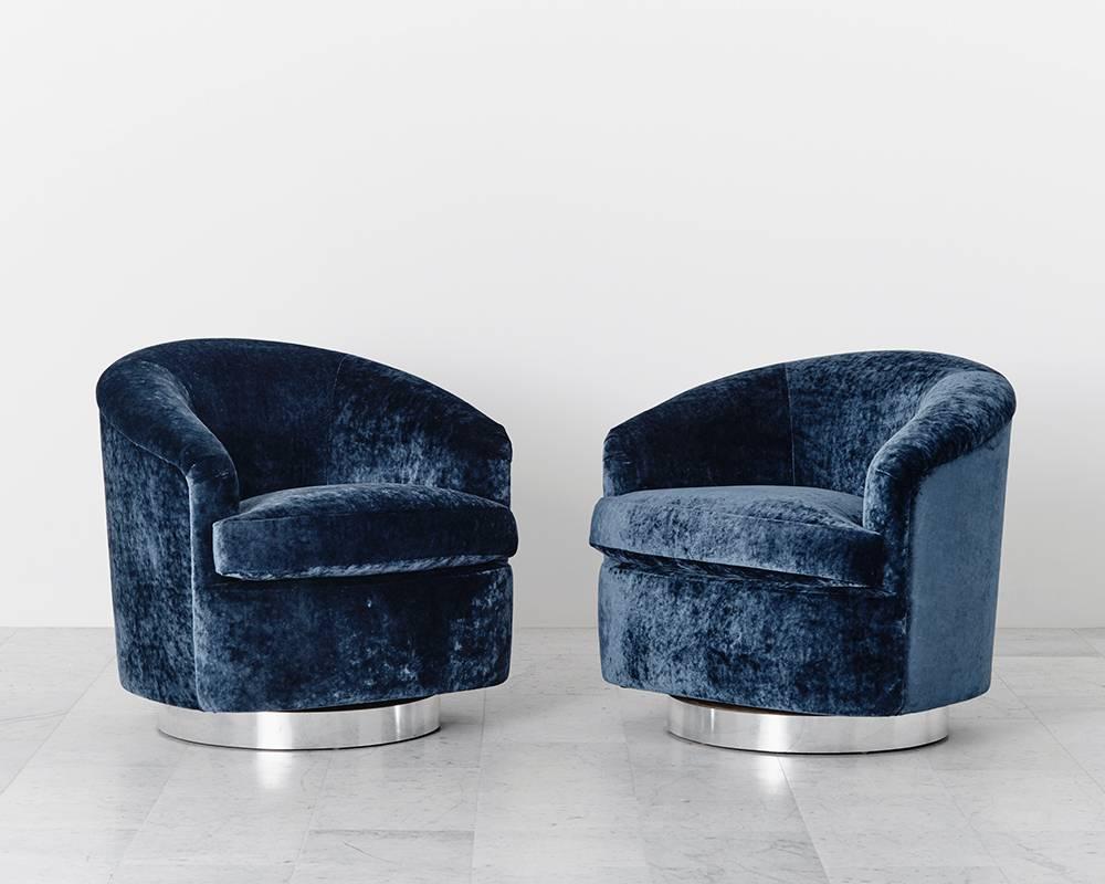 A beautiful pair of swivel chairs designed by Baughman, each has a circular chrome base that swivels with ease. Elegant in design, they are also extremely comfortable, offering ideal proportions and back support. The chairs have been newly