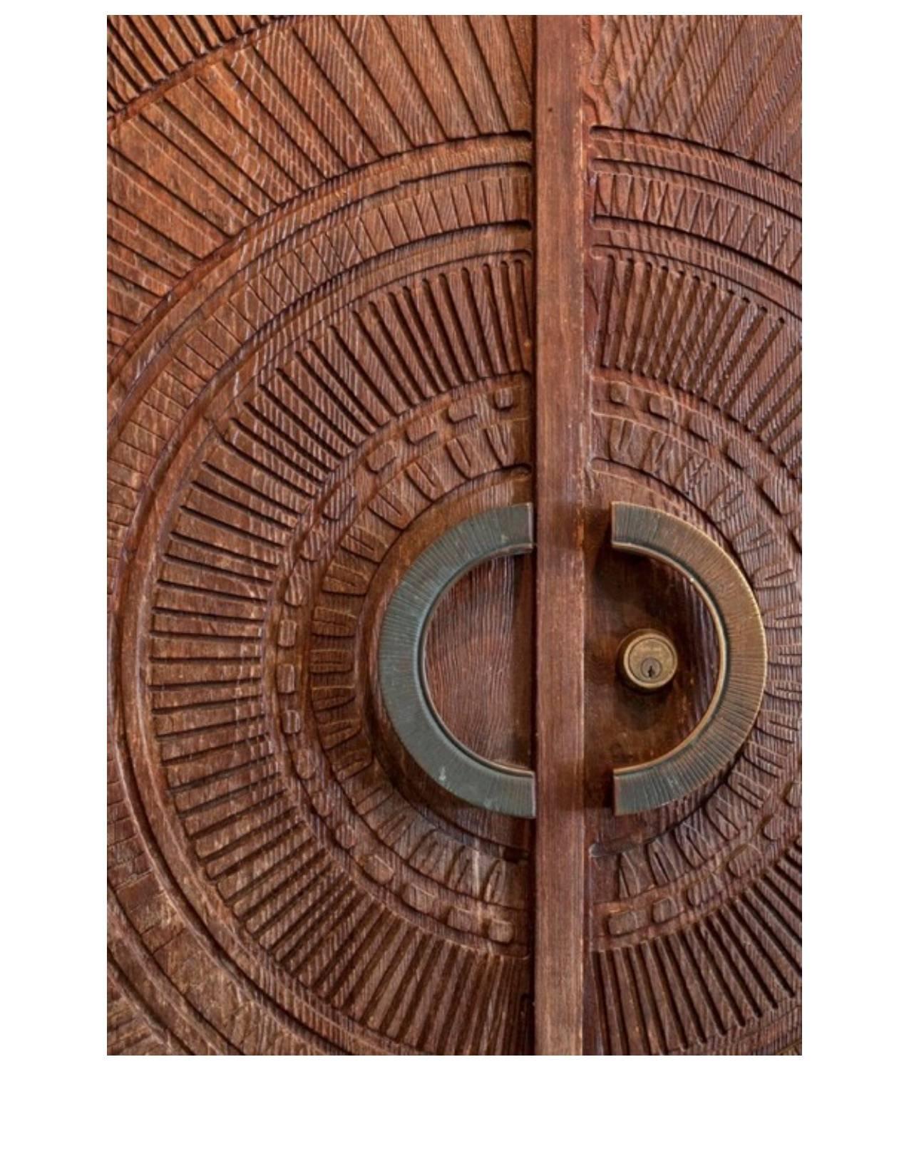 Magnificent double sunburst doors by Billy Joe McCarroll and David Gillespe, USA, circa 1970s. “Exterior” side in carved and impressed 2″ thick redwood in a radiant sunburst pattern adorn both sides of these doors. “Interior” side ebonized with