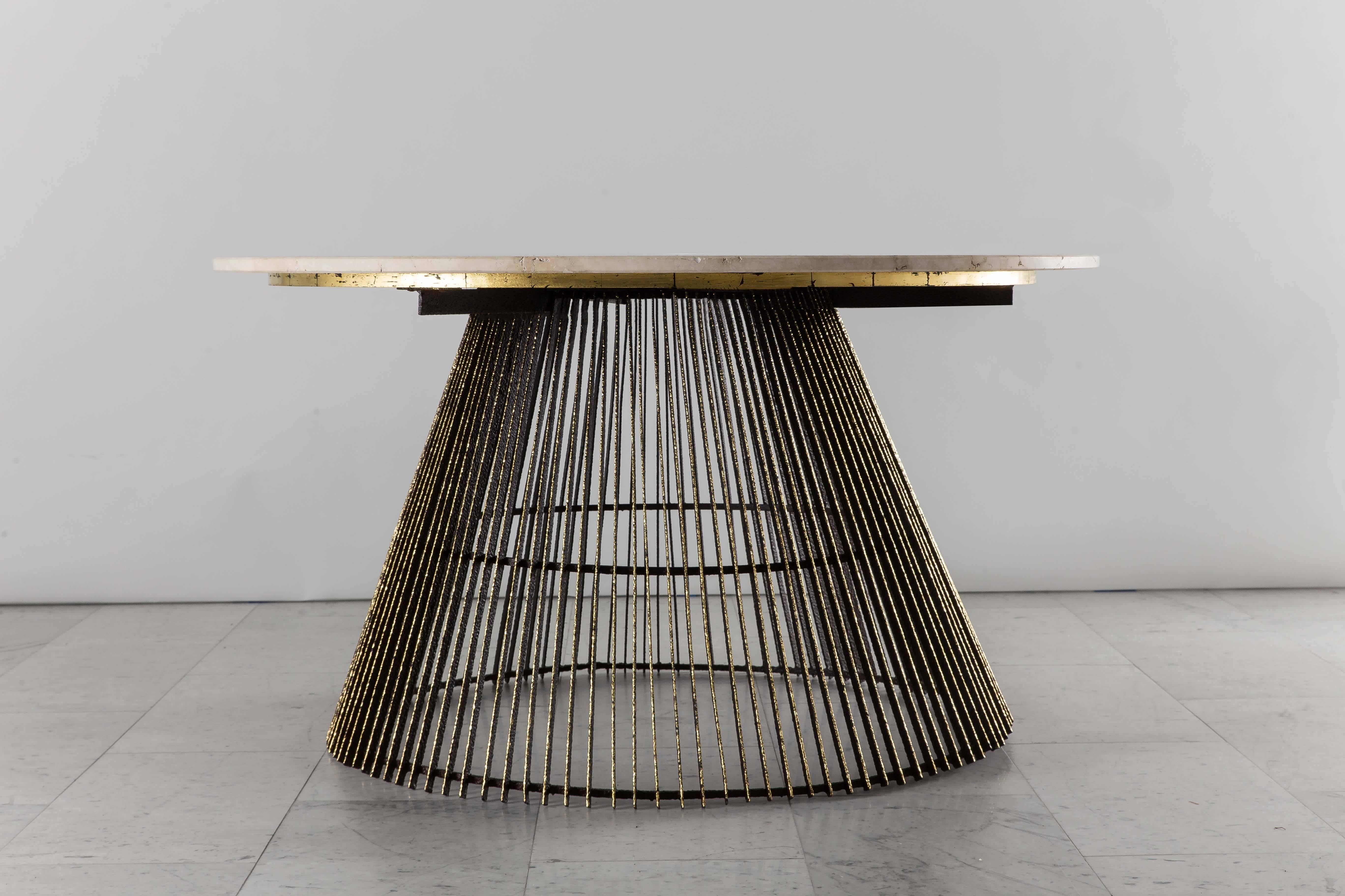 An early studio low or center table by Paul Evans featuring the artist’s handmade gilt steel work. The original, unpolished travertine round top offers a striking contrast to the impressive gilded steel cage beneath it. The gilding is elegantly