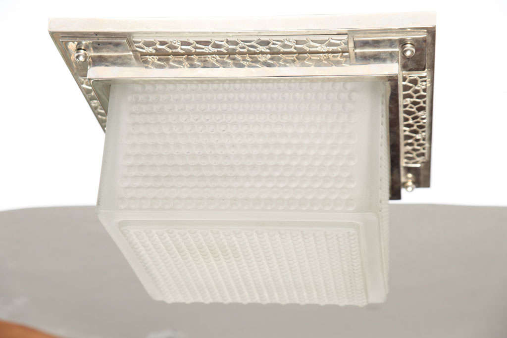 A French Art Deco ceiling flushed square fixture in molded frosted glass mounted in nickel-plated bronze frame, circa 1930. Signed Robert Caillat in the mold.