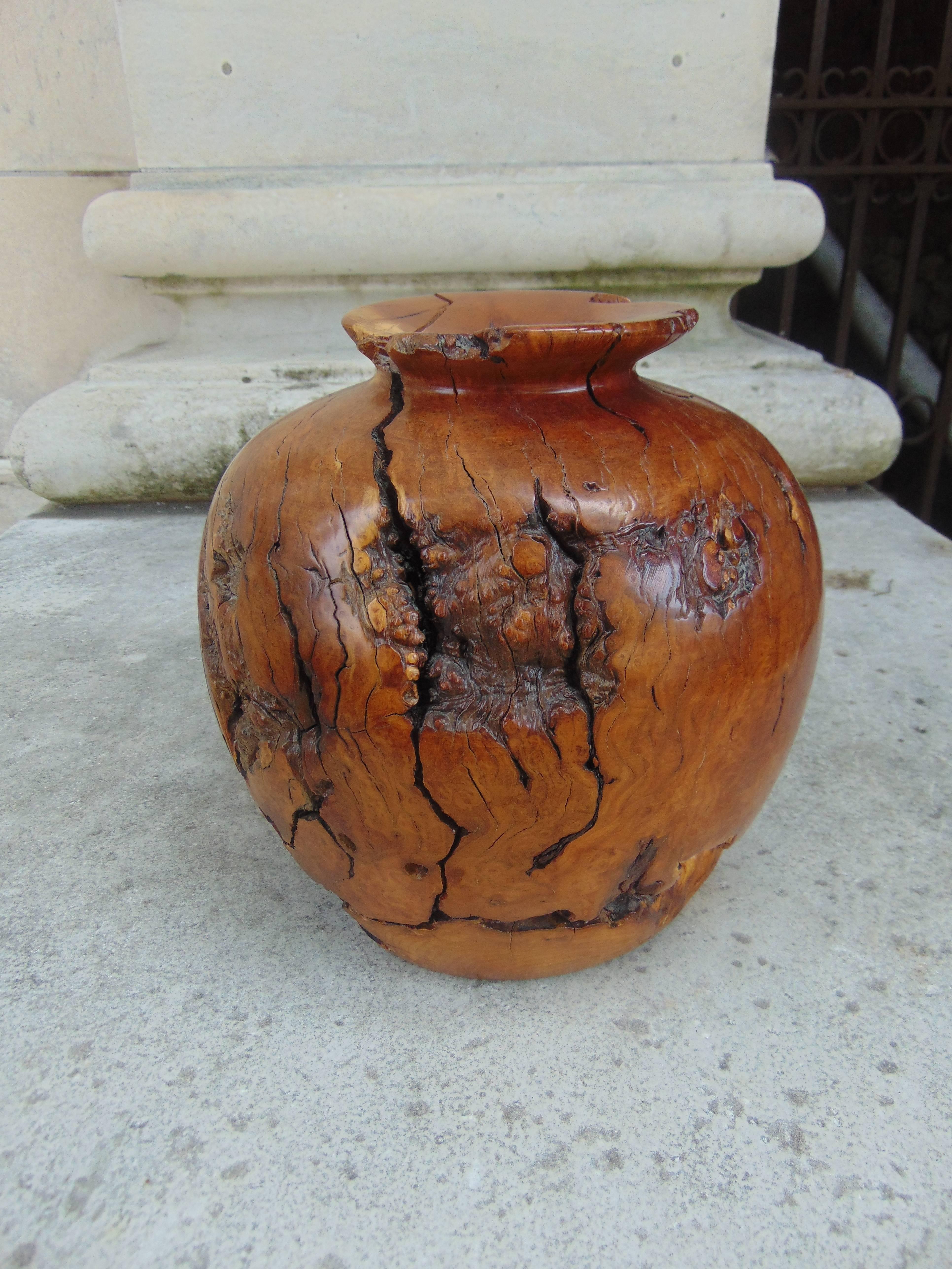 A carved solid wood vase or candleholder.