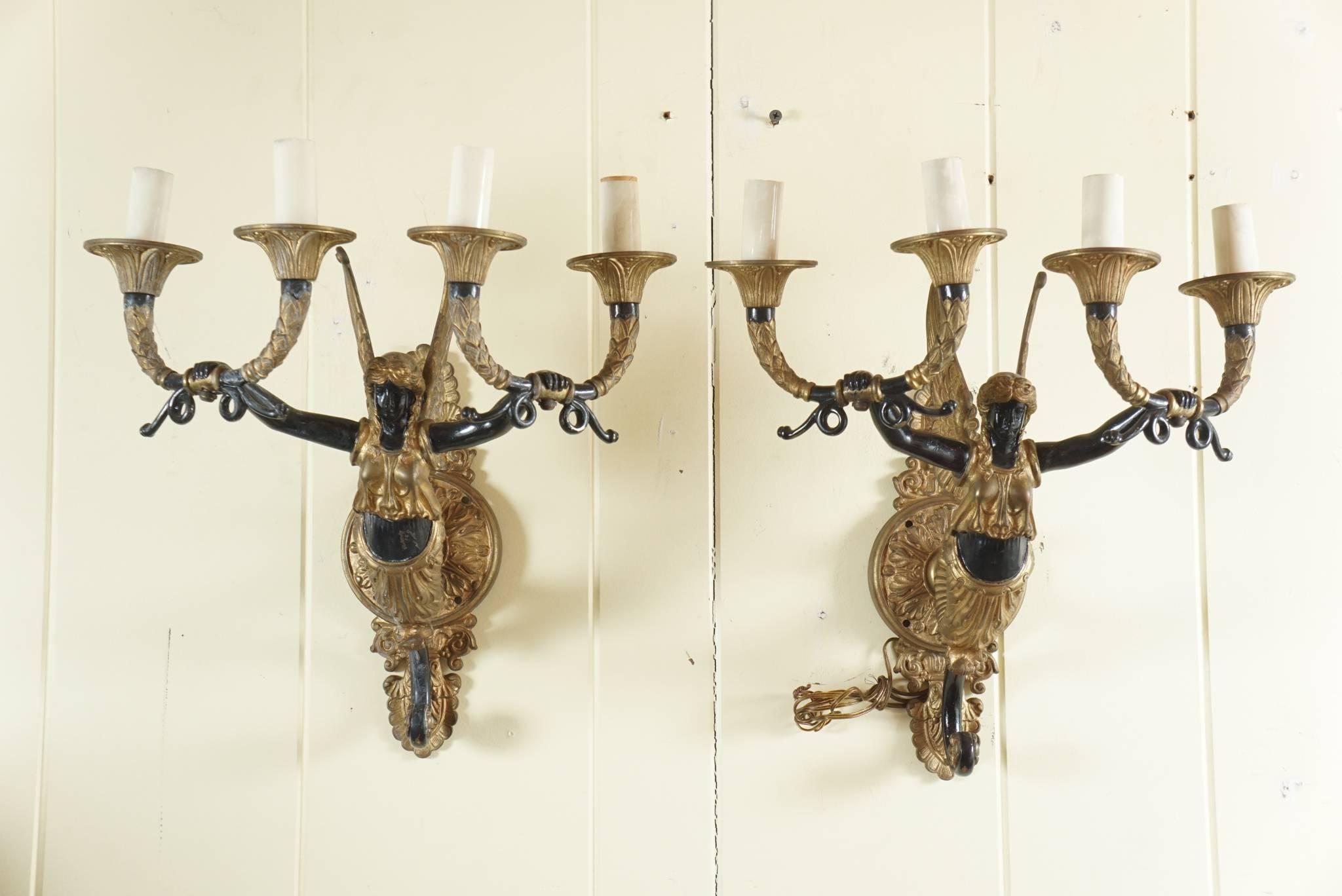 Beautiful pair of French bronze and black four light sconces.