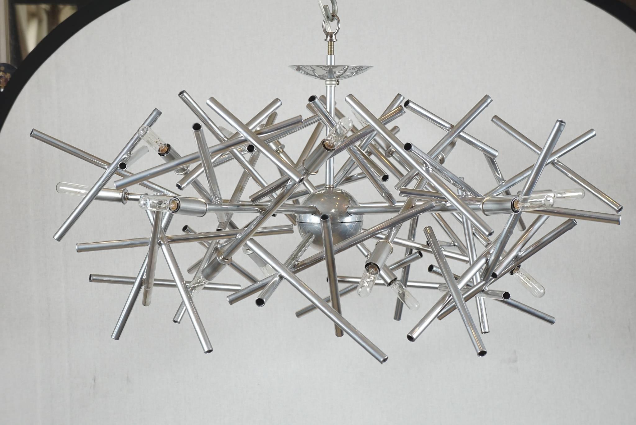 This is an angular momentum chandelier with a nickel finish by Lou Blass. All orders are custom-made to any size and shape with thousands of finishes to choose from. It usually takes 6 to 8 weeks for completion.