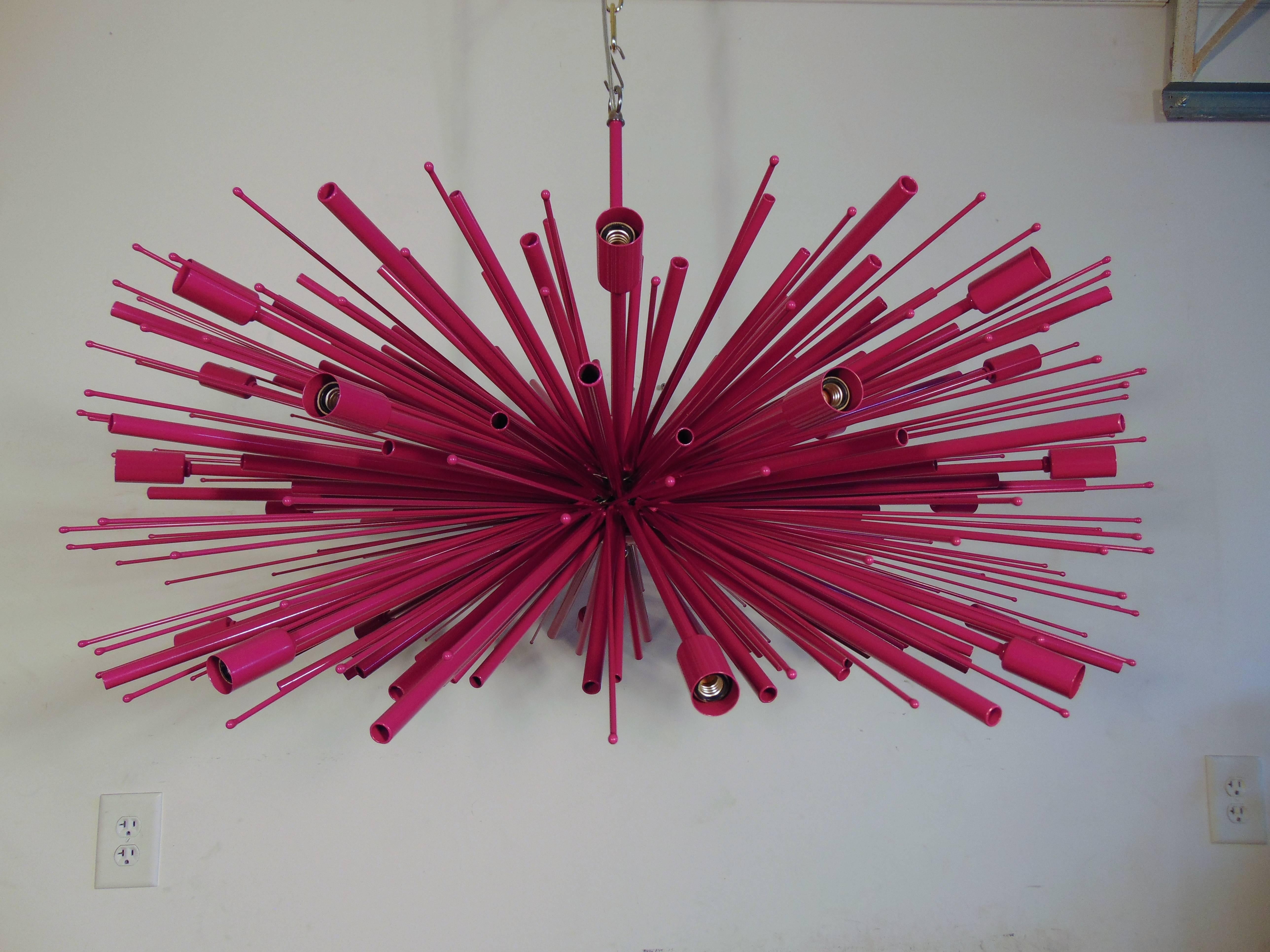 A custom-made Lou Blass chandelier, supernova executed in wild fuchsia finish. From top of stem to bottom of fixture is 25 inches. This chandelier has 24 lights, and the maximum wattage per socket is 60 watts, Because it has candelabra base sockets.