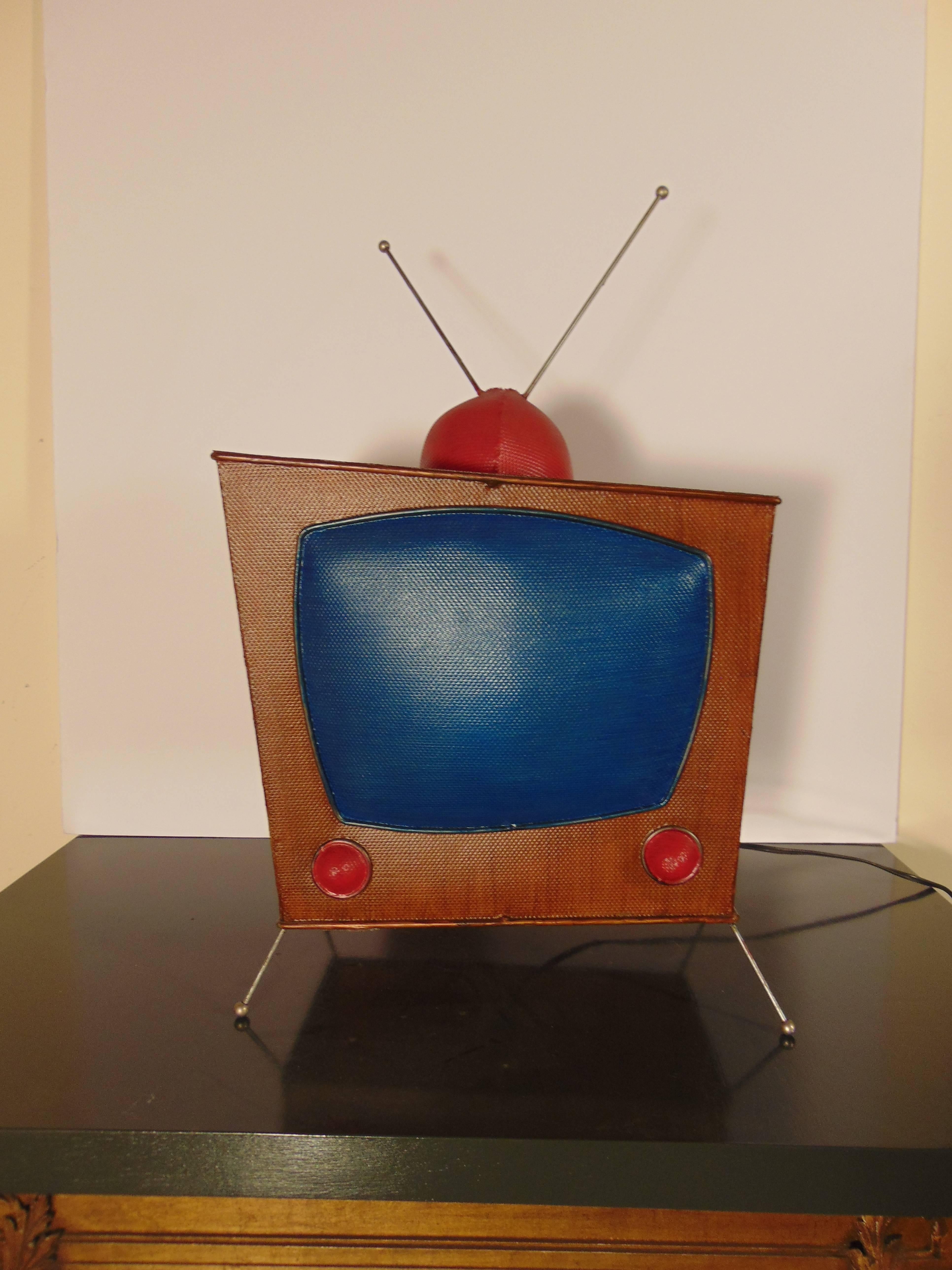 Television desk lamp by artist Daniel Sadler (1957-2004.) This lamp is made from a unique medium, consisting of a wire mesh and plastic composite material, formed onto a welded wire framework, which was then hand-painted.