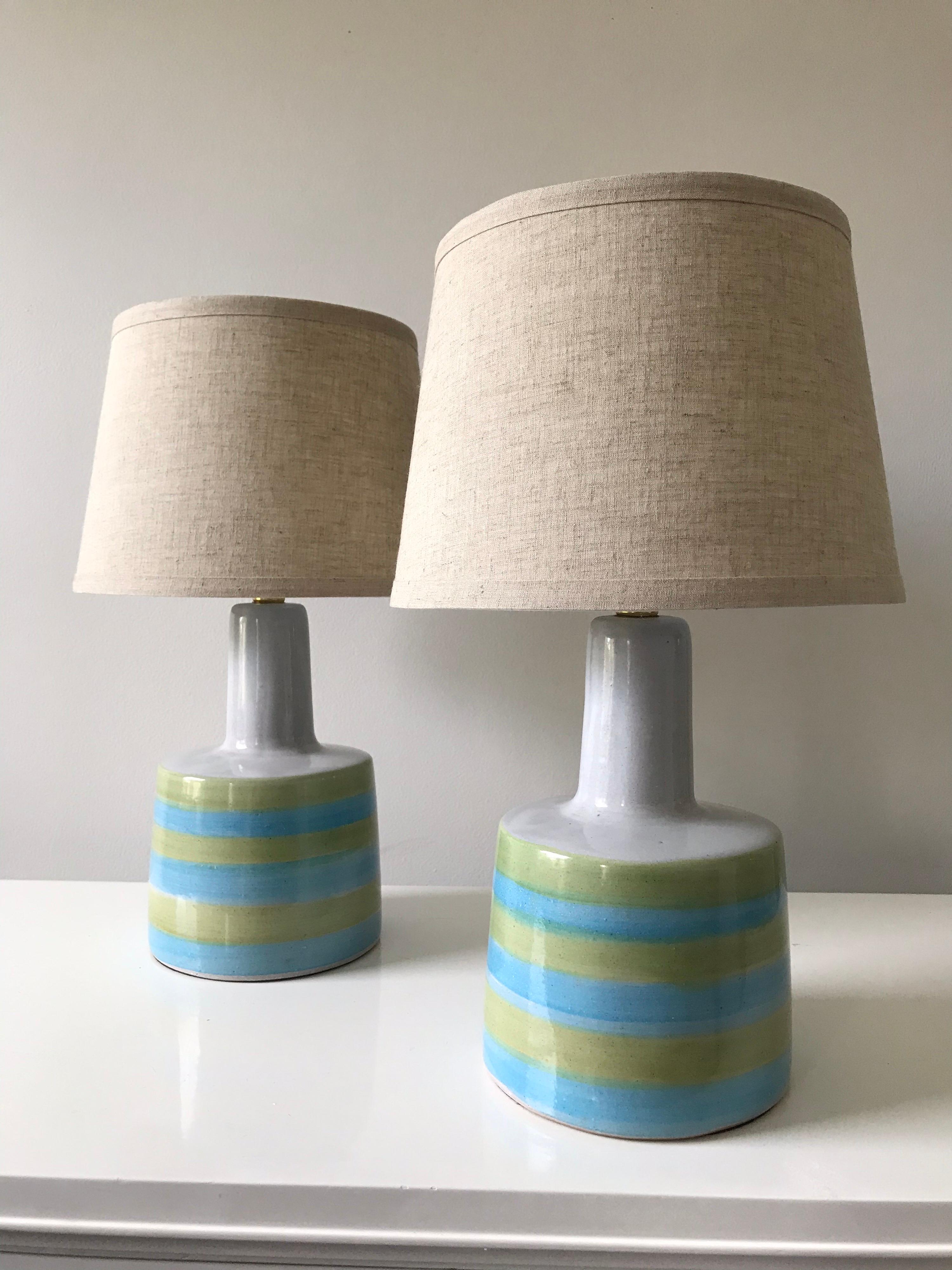 Wonderful pair of table lamps designed by Jane and Gordon Martz for Marshall Studios. Lamps feature thick white, green, and blue stripes. New shades, electrical components appear updated at some point.

Measures: Ceramic width 6.5