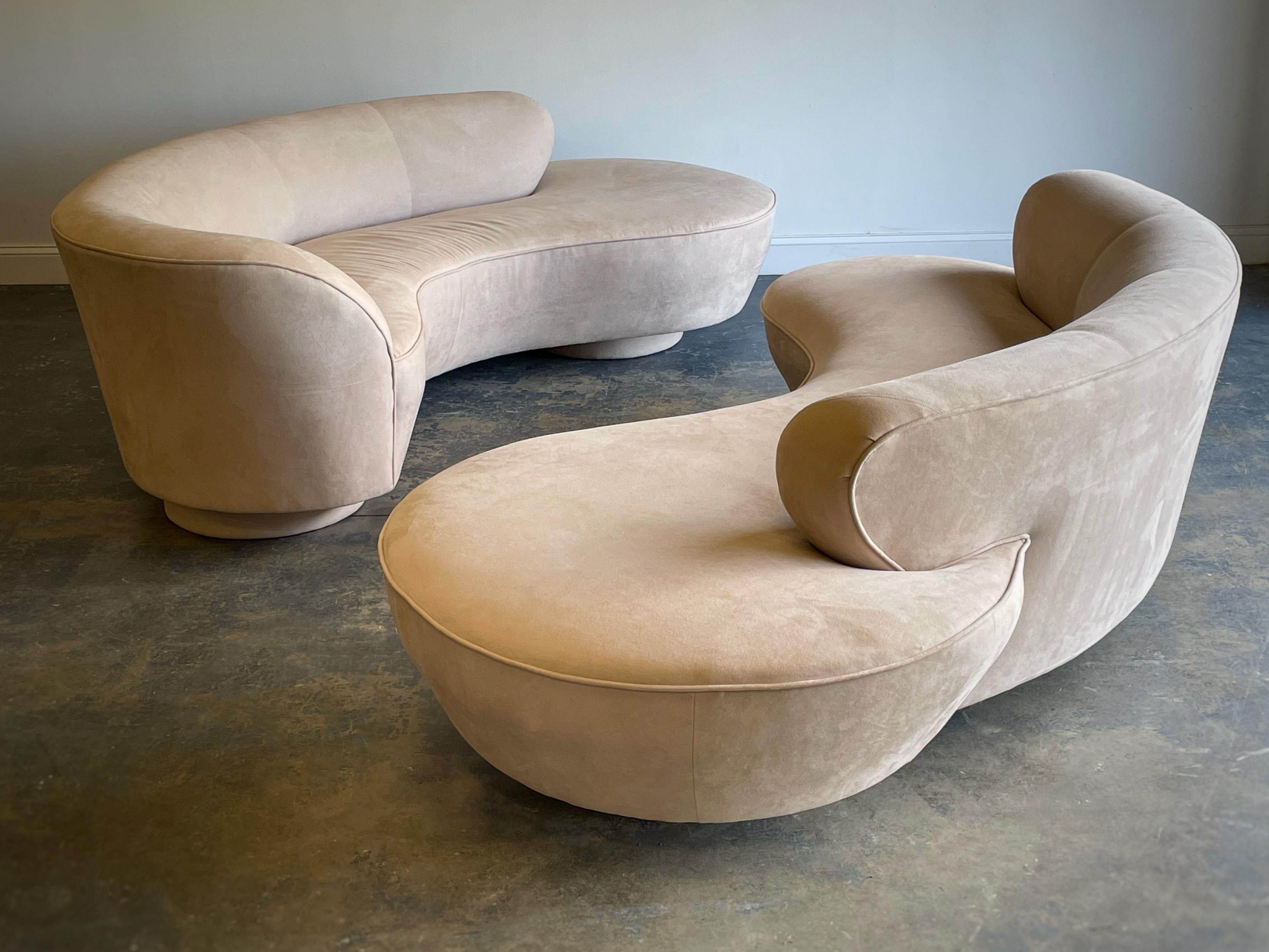 Original pair of matched Vladimir Kagan sofas for Directional. Iconic serpentine freeform design, one of which having an arm. Upholstered base with Lucite center support. Directional tags present.