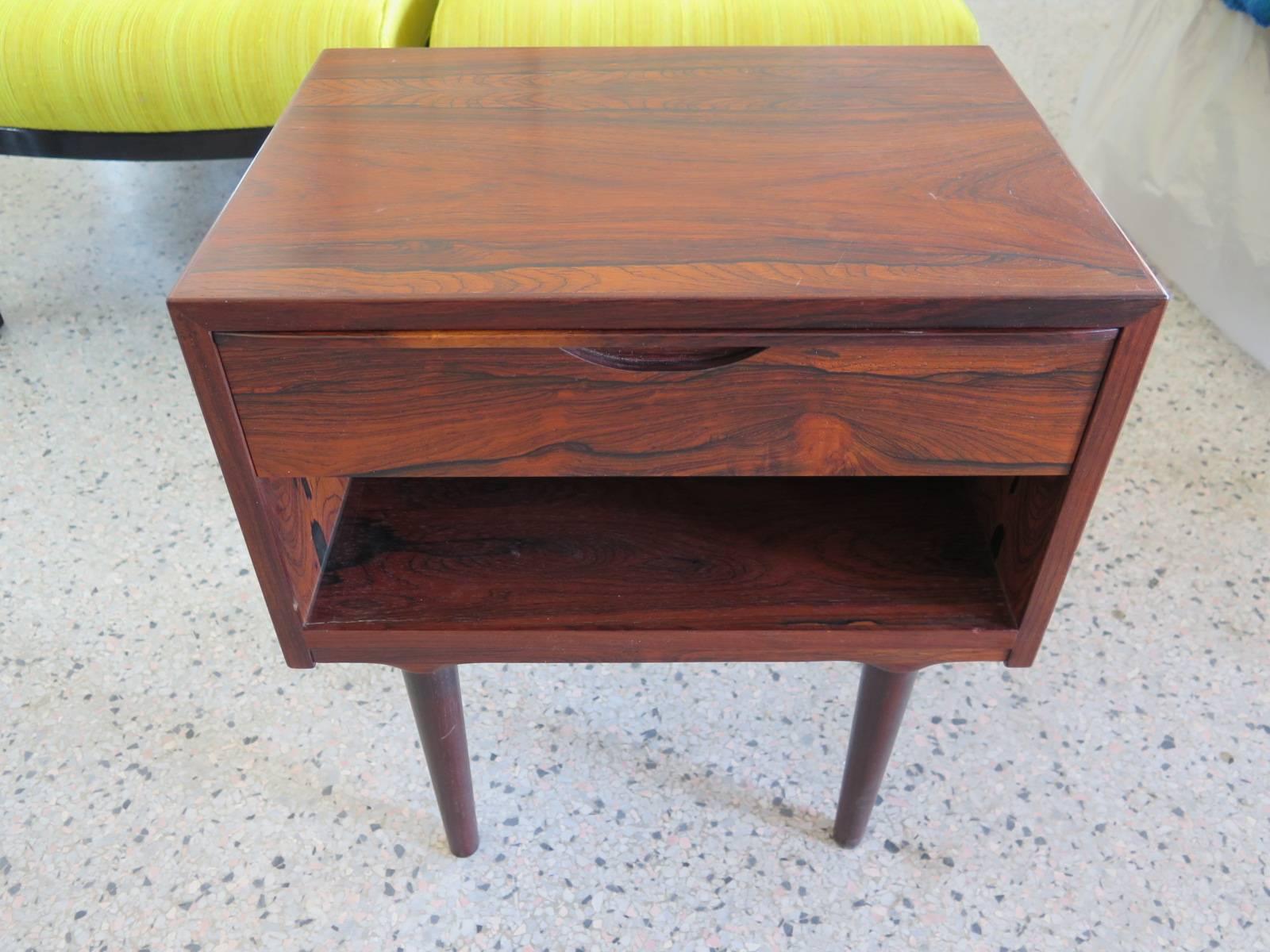A rare Arne Vodder/Odense exquisite nightstand in highly grained rosewood. Finished back, sculpted drawer detail, tapered legs.