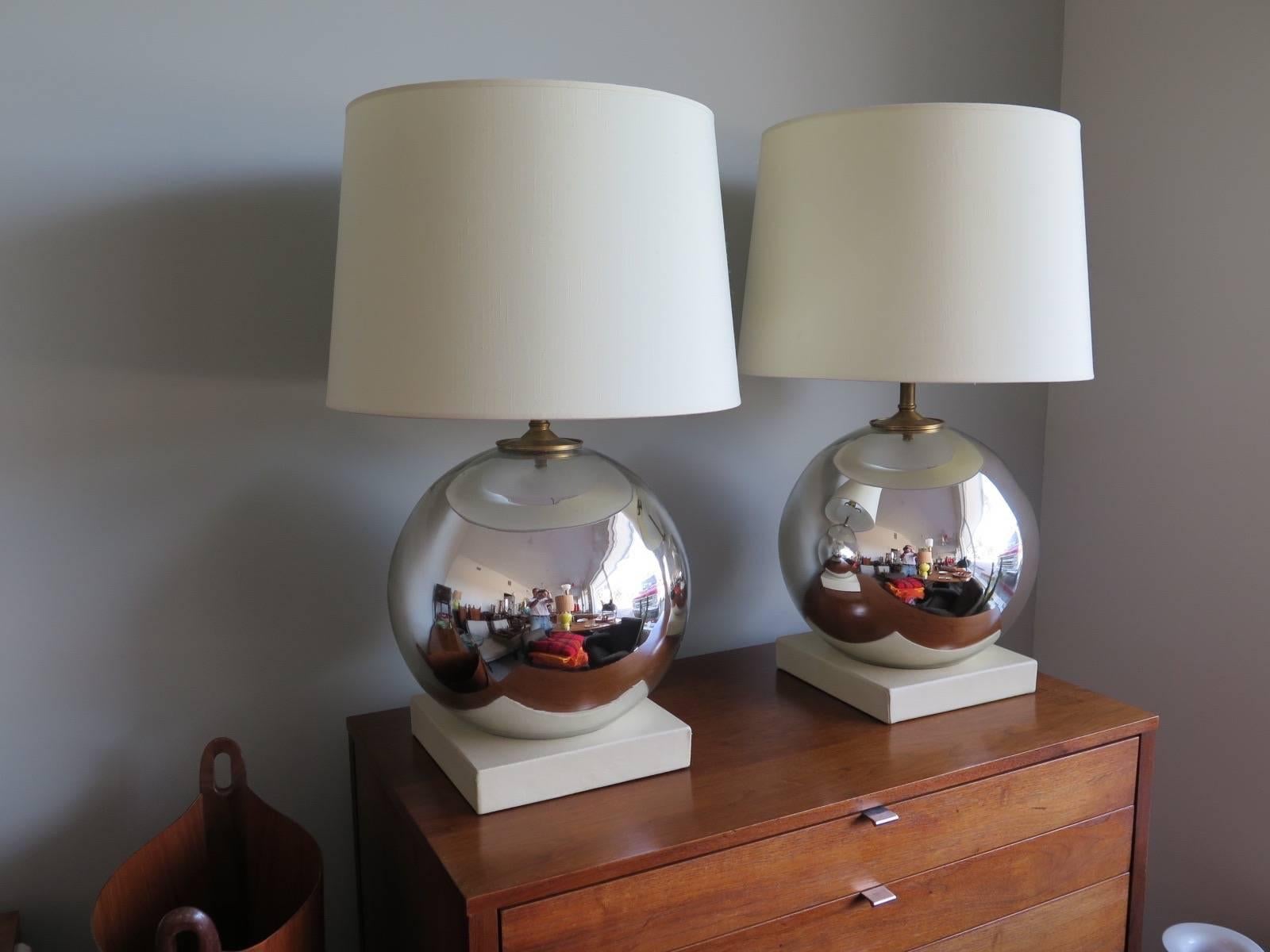 A pair of interesting mercury ball shaped lamps, made in Italy. Original linen shades, solid brass hardware with heavy solid brass finials and hand stitched leather wrapped bases. Measure approx. 29.5