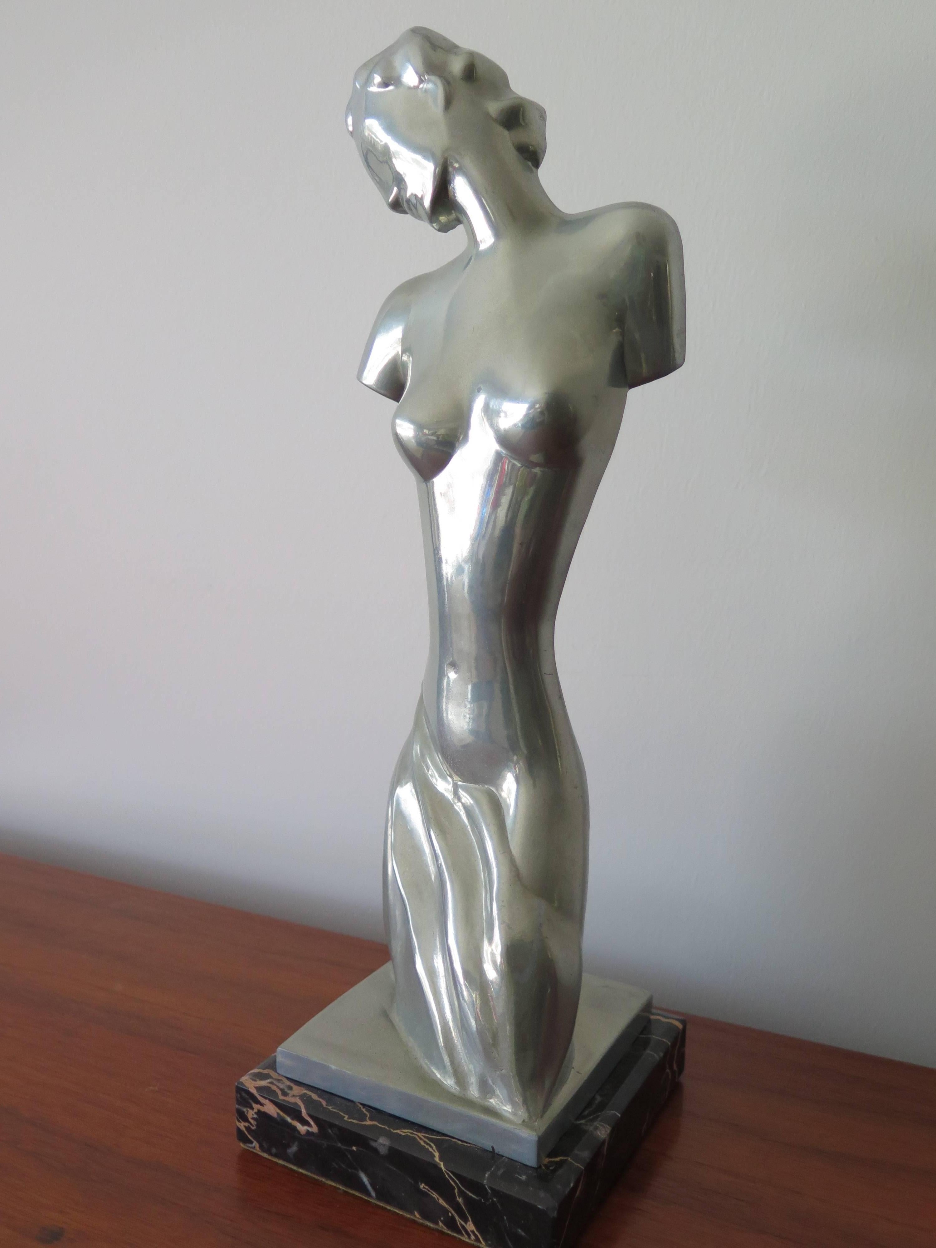 An unusual, stylized Art Deco statue of Aphrodite, goddess of love. Polished pewter on a marble base. Approximate 13.5