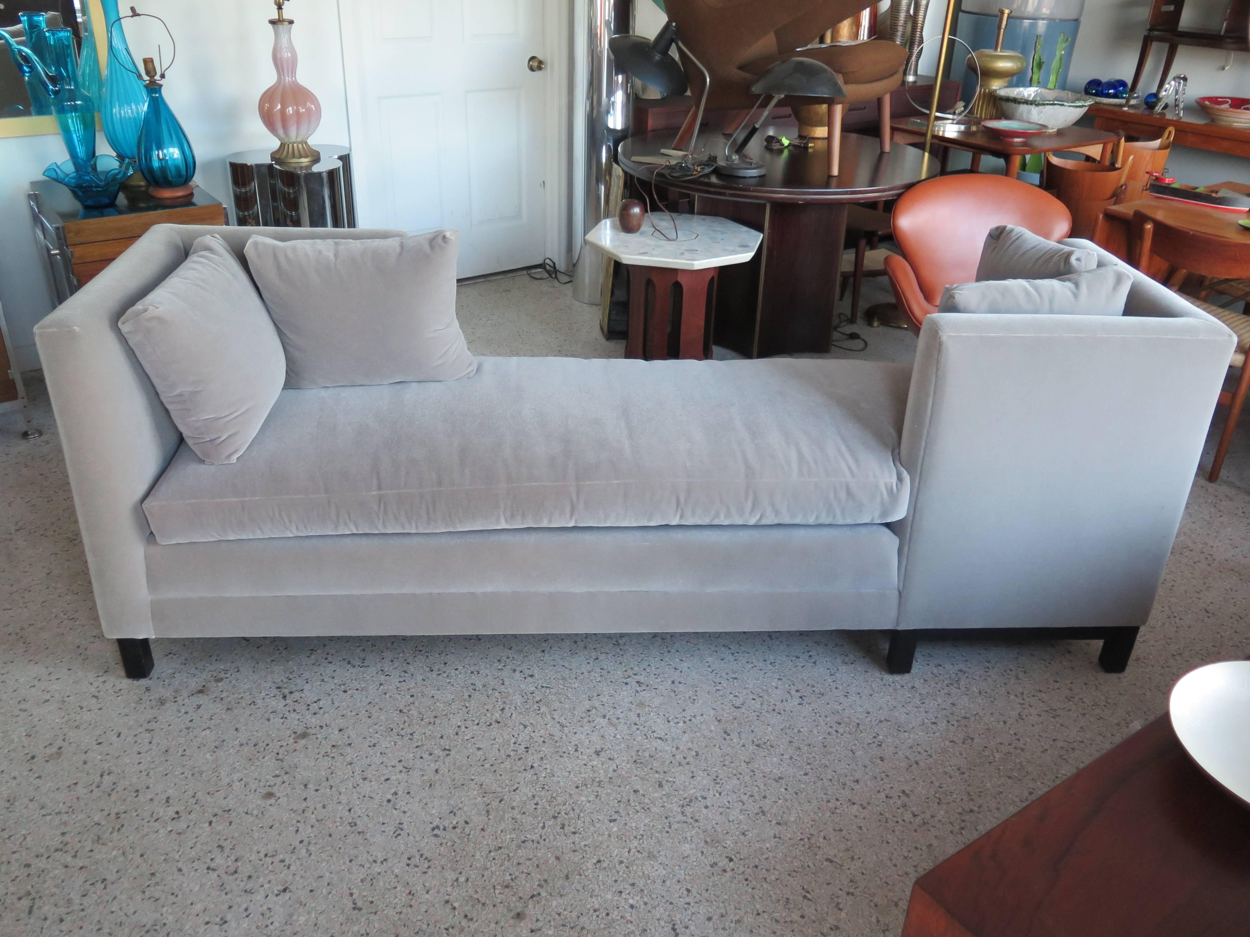 An elegant Harvey Probber tete-a-tete sofa. Ebonized base.