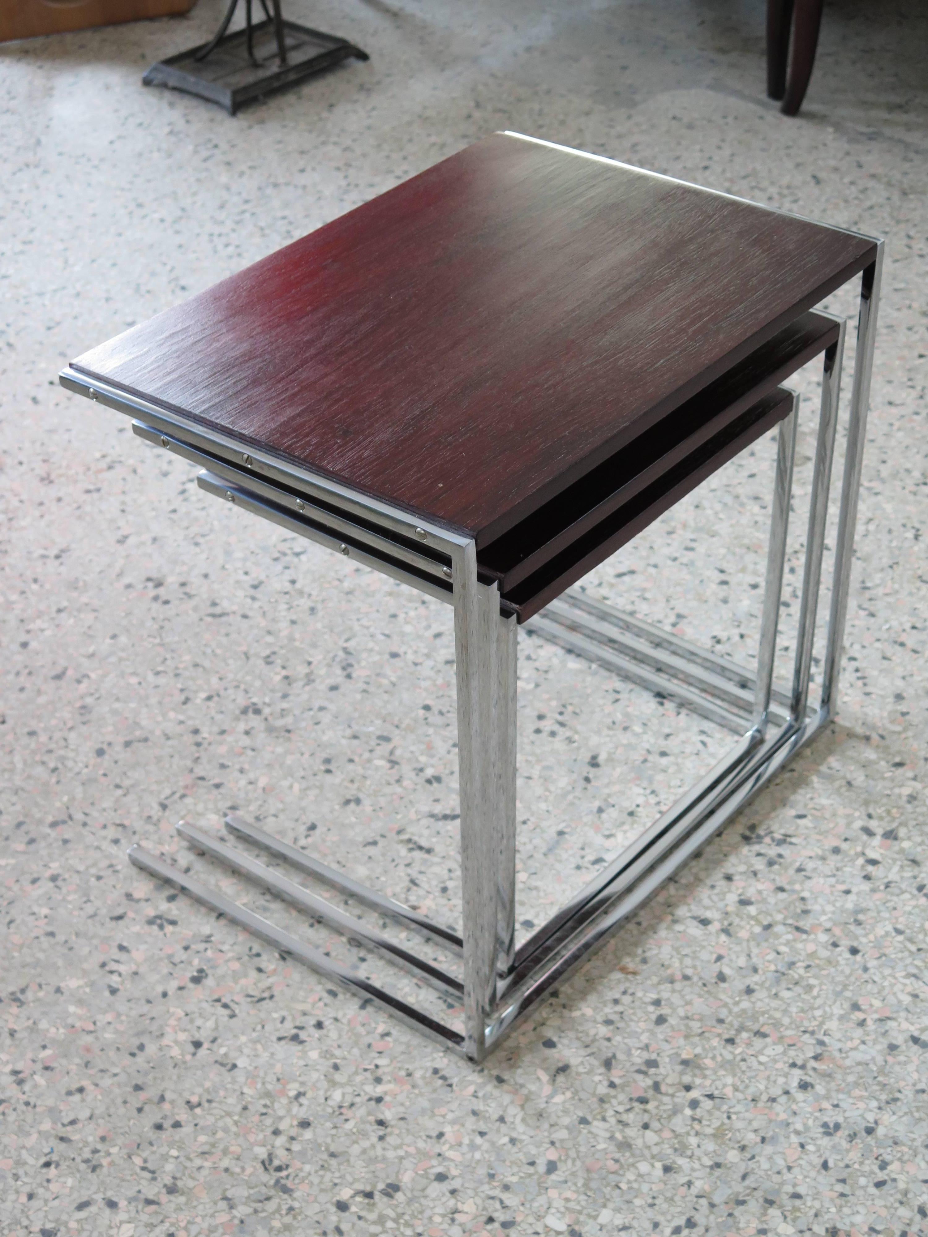 An unusual set of three nesting tables, rosewood or chrome cantilevered legs.