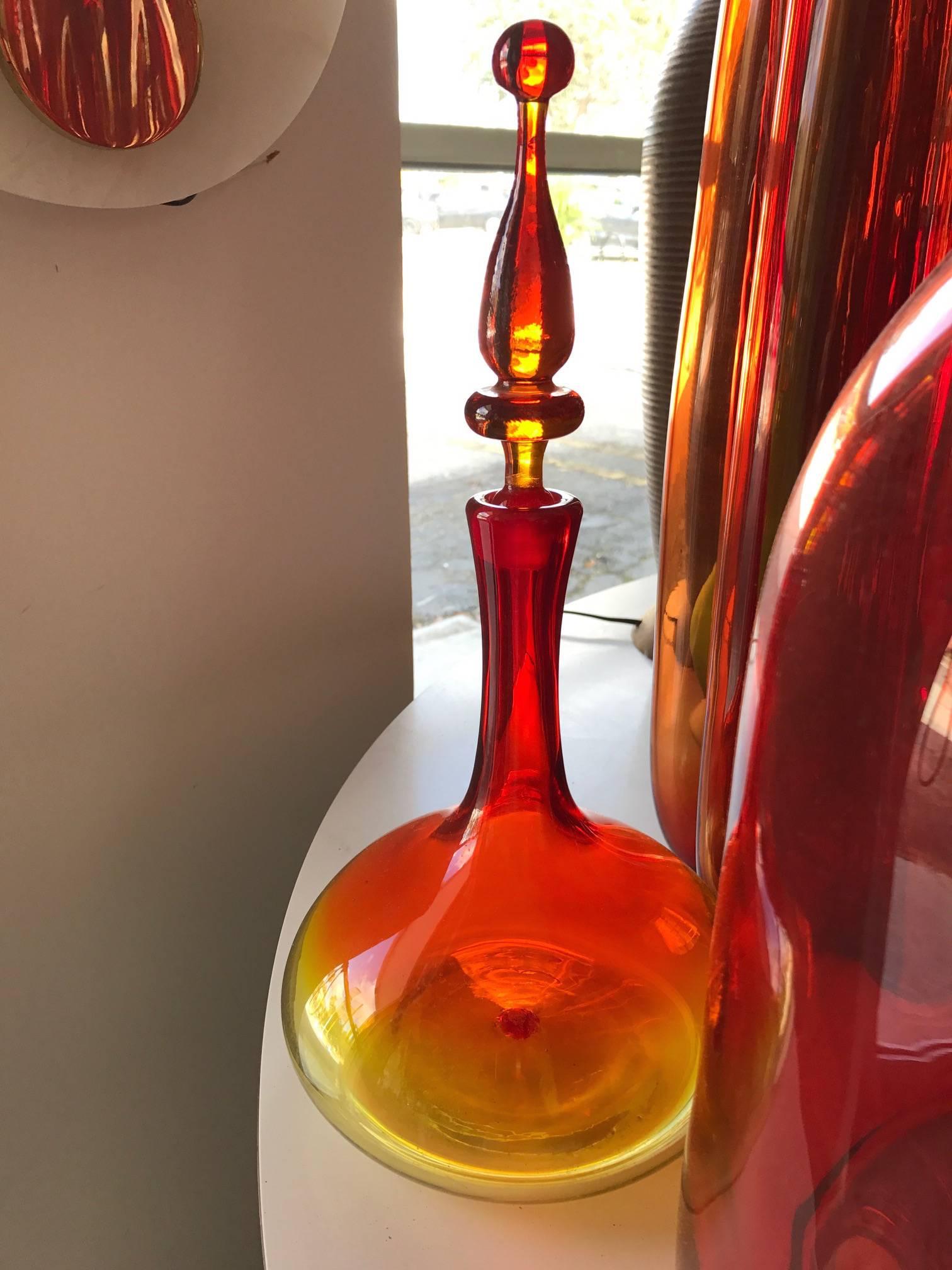 A collection of large, red-orange Blenko pieces, largest measuring 33.25" H.