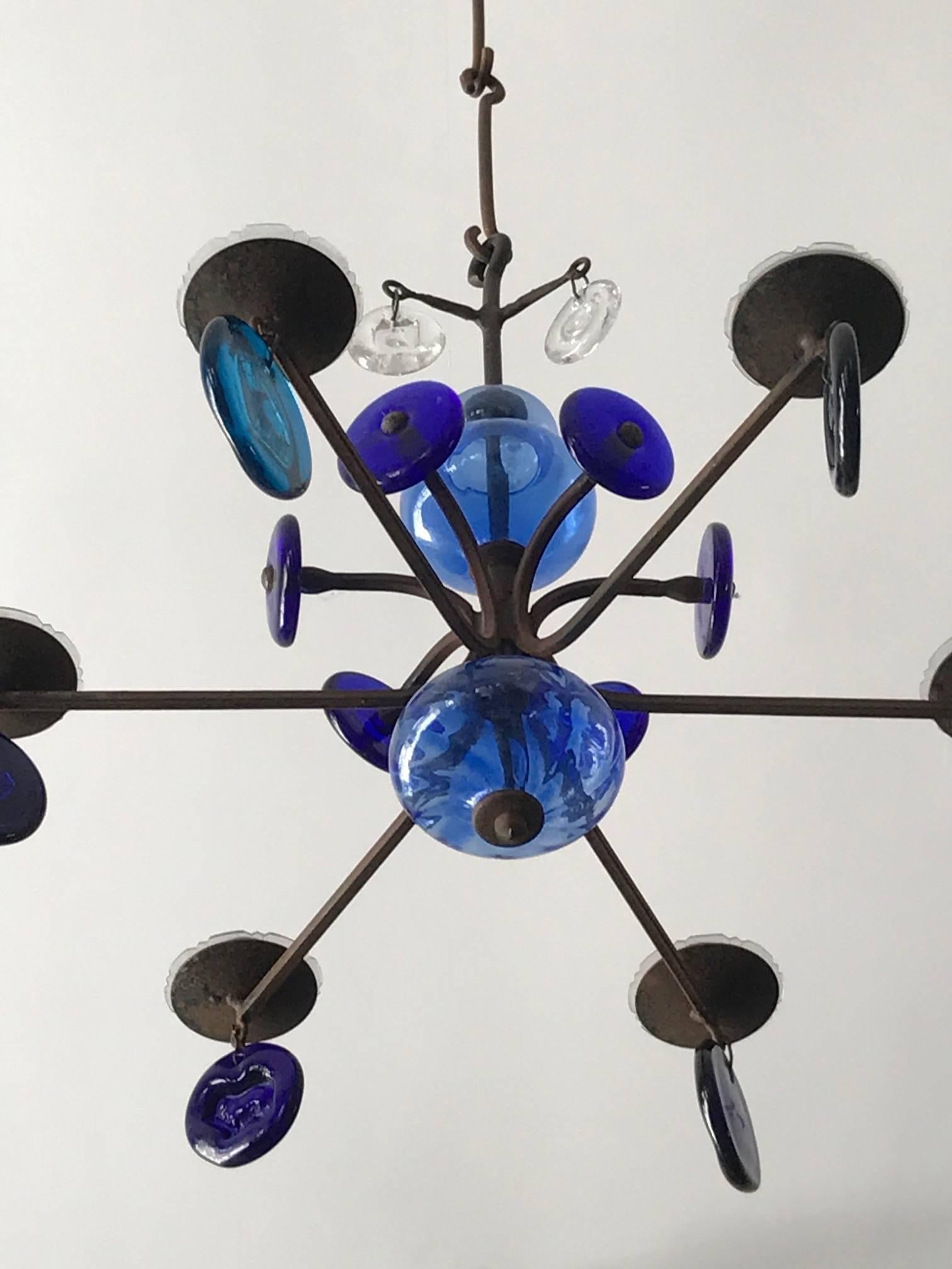 A charming chandelier by Erik Hoglund for Kosta Boda. Glass and wrought iron.