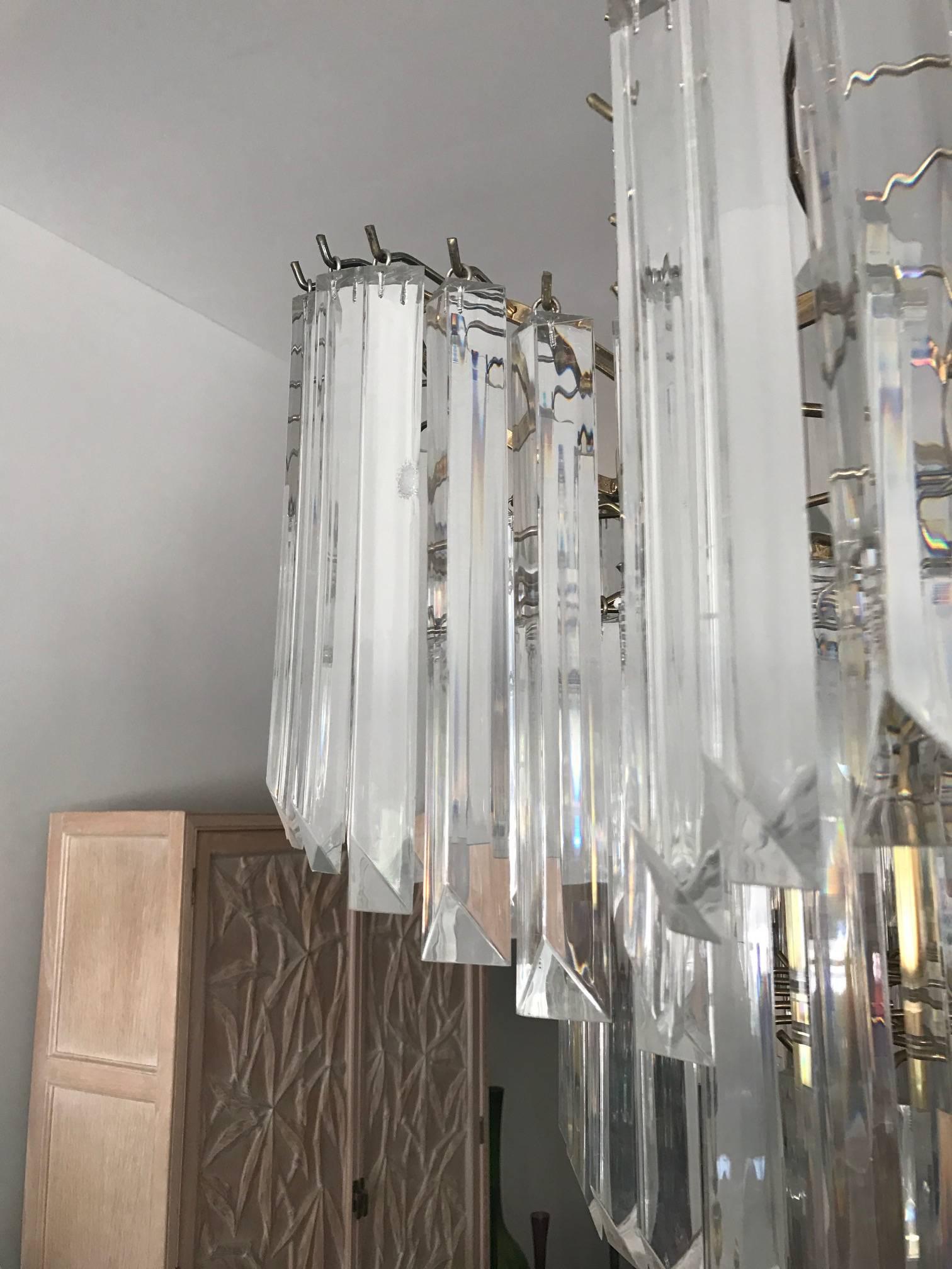 A massive eight-tier chandelier by Triarch, circa 1970s. Lucite prisms, camer style, measuring approx. 6 ft , 30